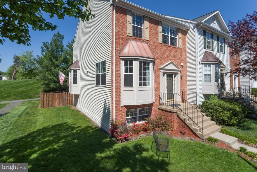Tucked away in a small enclave, within Ashburn Farm single family homes,is a bright end unit brick-front townhome w/dual Bay windows, wood FP, deck, fenced rear yard; terrific views & walk out basement. Walking path directly to Sanders Corner Elementary. Stone Bridge HS. Cosmetics needed to make it your own! Fabulous location Surrounded by common area,stream & fields. W/in 4 Miles of new metro!