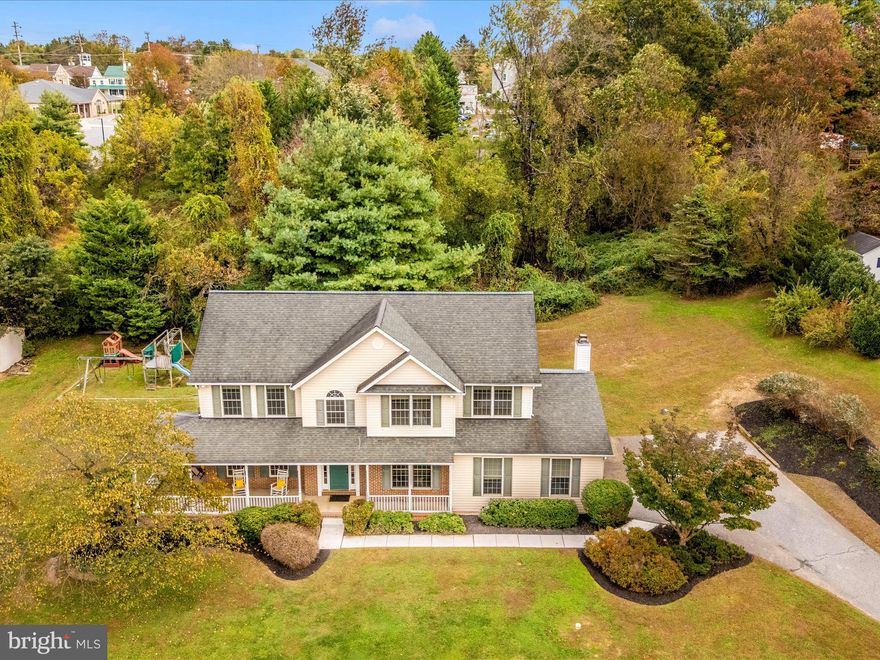 Beautiful Colonial on over an acre of land in Mt. Carmel Meadows! Peaceful Country Living with Easy Access to Hunt Valley and Baltimore. Enjoy sunsets and quiet evenings from your classic wraparound front porch and take in morning sunrises from the expansive back deck. Nestled on a quiet cul-de-sac street this inviting 4-bedroom, 3½-bath home offers over 3,400 square feet of living space on more than an acre of private, tree-lined land that backs to woods. 
Located in the highly sought-after Hereford School District—Sparks Elementary, Hereford Middle, and Hereford High—this home blends small neighborhood charm with the open, peaceful feel of Monkton’s countryside. Step into a grand two-story foyer with elegant hardwood floors and 9-foot ceilings on both the main and upper levels, creating a bright and spacious atmosphere throughout. The gourmet kitchen features an island, 42-inch cabinetry, gas cooking, nice-sized pantry, and a sunny bump-out window making space for a large table. A warm and inviting family room with a wood-burning fireplace provides the ideal spot for cozy winter evenings -- Enjoy movie nights with the smart TV and surround sound which will remain at the property. Upstairs, the luxury primary suite showcases a cathedral ceiling, massive walk-in closet, and a spa-like bath with a soaking tub and separate shower—your own private retreat! 

The lower level has a large finished rec room, 8-foot ceilings, a full bath, walk-up access to the side yard and abundant storage which is ready to become a recreation room, home gym, or guest suite. Major home updates that bring peace of mind: HVAC system (2017), 50-year architectural roof (2014) with transferable warranty, Water heater and Culligan full-house water treatment system with reverse osmosis water system that goes to the kitchen sink (2023). Located in scenic Monkton, this property offers true country living with convenient access to Hunt Valley, Baltimore, and I-83. You’ll love the quiet setting and easy commute, with nature and amenities close at hand. Walk to the local library or take a short drive to the Torrey C. Brown Rail Trail for miles of biking and walking along the Gunpowder Falls River. Nearby parks, nature preserves, and Hunt Valley Towne Centre add to the area’s exceptional quality of life. Welcome home!
