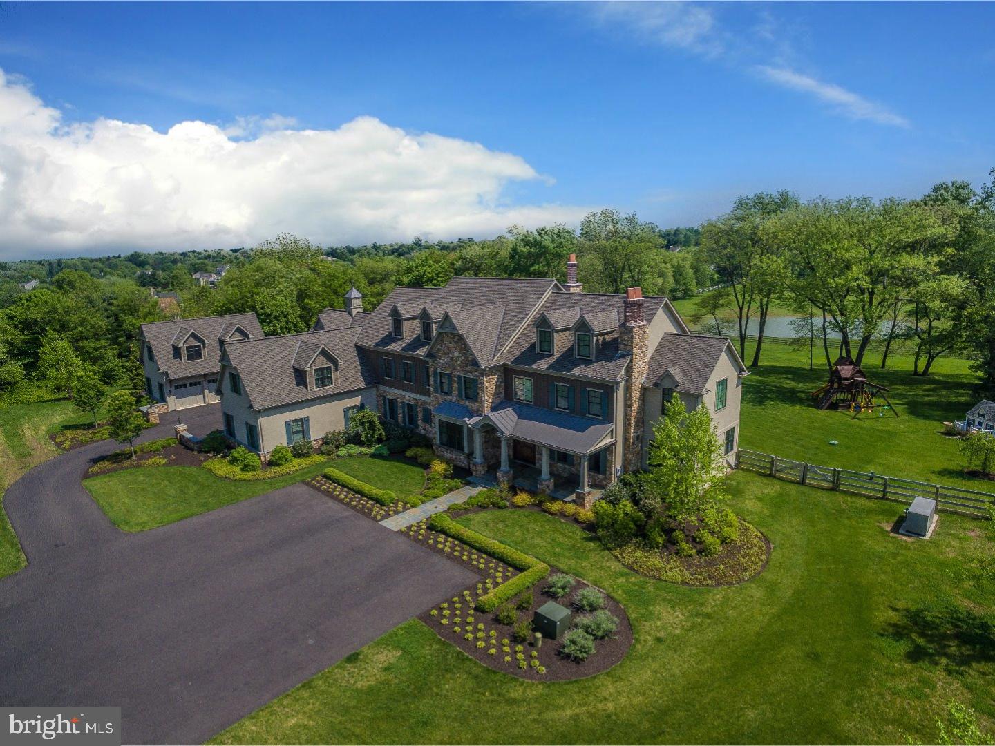 This home has it all! Come see this exceptional, custom crafted masterpiece by Mack & Roedel. Located up a serene, gated hill top is this pristine, better than new design in the heart of Upper Makefield. This amazing space flanked with hardwood flooring evokes instant relaxation as you take in the lush green views from every window. An elegant dining room boasts a gorgeous Butler's Pantry and the impressive gourmet kitchen is sure to WOW. It is equipped with a Sub Zero refrigerator, Wolf Range and Double wall ovens and every amenity you can imagine. Adjacent to the breakfast area is a generous Gathering room with an inviting wood-burning fireplace, 2-sided built-in Aquarium and built in book shelves. Three floors of living space, this home has an impressive 6 Bedroom Suites with an additional Guest Apartment that is accessible thru the main home and has a separate entrance. An Entertainers dream, the Lower Level has a spectacular custom Bar, Movie Theater, Full size Gym, Arcade and a full Bath. Elevator access to 3 levels. Stocked pond for fishing, Geothermal system, 8 car garage for the car enthusiast including a 2 car garage with heating and cooling. Beautiful pool and covered terrace with outdoor fireplace, exceptional Bedroom sizes. Finished 3rd floor for additional living space or storage, slate mudroom with cubbies and dog shower, Main Suite with Juliette balcony overlooking the yard with pond view. Don't pass up the chance to own this once in a lifetime property!