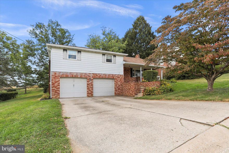 Welcome to this beautifully maintained multi-level split in the sought-after Dallastown School District! This home boasts numerous updates, including a remodeled kitchen and baths, a newer roof and newer HVAC system for peace of mind. Step inside to the main level where you’ll find an updated kitchen featuring granite countertops, subway tile backsplash, stainless steel appliances, and gas cooking.  Easy care flooring in kitchen, living and dining room! The dining area and living room are beautifully done with wainscoting and living room offers a brick fireplace. Upstairs, the spacious primary suite offers its own private bath, while two additional bedrooms and a full hall bath complete the level. The first lower level is a showstopper with its stunning stone fireplace, laundry center, and convenient half bath. From the family room, step out to the huge screened-in porch—perfect for year-round entertaining. Head down another level to discover a fabulous rec room that’s ready for football season and game day gatherings, along with extra storage and a workshop.  Outside, enjoy a two-car garage and a huge backyard ideal for kids, pets, and endless family fun. All this is set in a wonderful, established neighborhood close to shopping, restaurants, and with easy access to Routes 83 and 30.