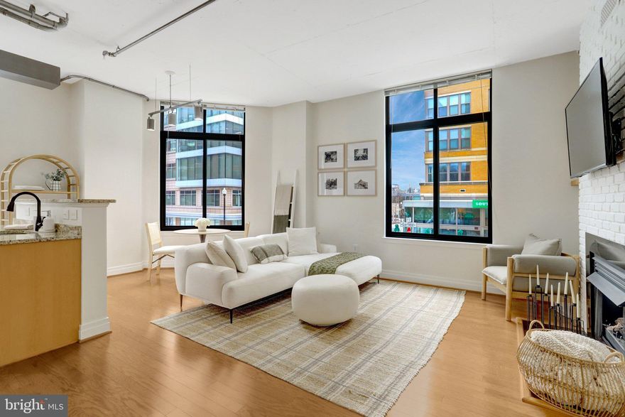 In the heart of Clarendon on a quiet tree-lined street, you'll find this updated 2nd floor 997 sq. Ft. 2 Br/2 Ba corner condo with reserved garage parking space + dedicated storage unit.  Enjoy open concept living w/10 ft industrial-style ceilings and nearly floor to ceiling windows.  The living area is especially cozy with a gas fireplace centering the entertainment space.

The gourmet kitchen features granite counters, SS appliances, gas cooking and loads of cabinet storage. Each bedroom w/its own en-suite bathroom bookends the living space, allowing for privacy whether for sleeping or working from home. The primary bedroom offers a walk-in closet and updated en-suite bathroom w/ soaking tub + separate shower. The second bedroom is generous-sized with updated bathroom + two closets. In-unit stacked laundry machines.

Freshly painted (2023); new hardwoods floor (2020) and bathroom updates w/new faucets + lights + mirrors (2025).

Residences at Station Square is a well-managed building with an on-site property manager, outdoor pool, party room w/billiards and lounge area. Reasonable condo fee also includes water/hot water.  Blocks to the Clarendon metro,  Trader Joe's, Whole Foods, and all of Clarendon’s restaurants/shops. Easy commute to DC/Tysons via Rte 50 or I-66.

This home offers the perfect combination of a Clarendon location, convenience and style!