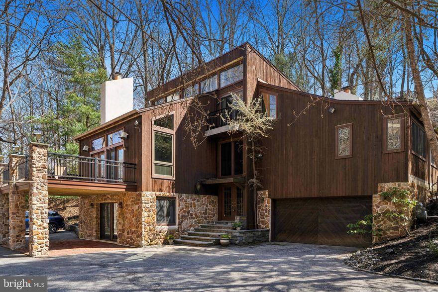 Experience unmatched luxury and privacy in this stunning home situated on a serene, nearly one-acre wooded lot, offering an exceptional living experience in the highly sought-after Lower Merion School District.  The home features 4 bedrooms, 3 full bathrooms and a stylish powder room, effortlessly combining modern design with family-friendly comfort. With convenient access to Center City Philadelphia, King of Prussia, and vibrant Manayunk, everything you need is just minutes away.

As you approach the home, wide flagstone steps lead you to the grand entrance, where a striking handmade copper portico welcomes you into a two-story foyer, complete with a dramatic domed chandelier that sets the tone for elegance. The open-concept main level is a showstopper, with recently refinished tongue-and-groove hardwood floors, expansive windows, and skylights filling the space with natural light.

The gourmet chef's kitchen is a true culinary masterpiece, featuring a premium Wolf range, a brand-new 48” refrigerator, spacious pantry, and glass-enclosed breakfast area. Seamlessly connected to the kitchen is the generous dining room, with a built-in for added functionality. Sliding doors from both the kitchen and dining room lead to the expansive wraparound patio and a private, flat backyard, surrounded by mature trees—an ideal space for relaxation or entertaining.  An electric hook-up is available for a hot tub.  French doors from the family room open to a brand-new, oversized front deck, offering tranquil views of the nearby creek and vibrant flowering trees. The family room features a large gas fireplace, a floating OLED TV, wood beams, and an abundance of glass, creating an inviting space for both entertaining and intimate gatherings.

The primary suite is a true sanctuary, complete with stained glass accents, a gas fireplace, new carpeting (2025), real wood beams, and a private balcony. The suite also features a spacious walk-in closet and a spa-like en-suite bathroom with an extra-large double vanity, a walk-in shower, and radiant heated floors.  On this level, you will find two additional nice sized bedrooms, along with a full bath.

This home also boasts three gas fireplaces—located in the living room, den, and primary suite—providing warmth and charm throughout the space.  The newly updated main-floor den offers soaring ceilings, skylights, wood beams, custom built-ins, a gas fireplace, and a wet bar with glass shelving, making it another area for both entertaining and relaxing.  A private office, accessible through the den or a separate entrance, features windows, its own HVAC system, recessed lighting, and built-in speakers.

The entry level includes a versatile bonus room (ideal for use as a den, playroom, or gym), w/sliding doors leading to the front patio, the fourth bedroom, a full bath,  a large storage closet and access to the two-car garage.

Additional features include a large, flat driveway, a whole-house generator, a new roof & skylight (12/2024), and a dedicated laundry room with updated top-of-the-line appliances, a sink, ample cabinetry, & built-in cubbies.
Surrounded by nature yet just minutes from urban amenities, this meticulously updated home on a quiet street is a rare find. Don’t miss the opportunity to make this private oasis your own!

Highlights:
• Lot Size: .84 acres (wooded &  private)
• 2-car garage (painted 3/2025) & large flat driveway
• Brand-new  (3/2025)expansive front deck w/creek & flowering tree views
• Large wraparound rear patio
• Private, flat, rear yard, New Fence (3/2025)
• Flagstone walkway & entry steps
• Soaring entryway w/handmade copper portico & dramatic domed chandelier
• Whole-house generator
• Chef’s kitchen with Wolf range & brand-new 48” refrigerator
• Real wood beams, ceiling fans, chandeliers & recessed lighting
• Laundry room w/updated top-of-the-line appliances, sink, w/2 built-in cubbies
• New roof (12/2024)
• All furniture is negotiable