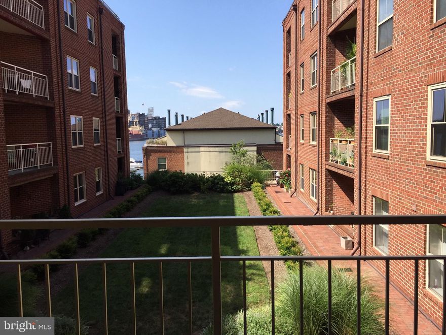 Wonderful 1 bedroom, 1- 1/2 bath Fells Point condo for rent. 4th floor looking south with a wrap-around balcony with a view overlooking manicured gardens and some view of the water, sliding doors to the living room. Light, bright, large unit in immaculate condition. Walk into the open living/dining area with wood floors. The oversized square kitchen has room for a table or island and features cherry cabinets and granite counters. The L shaped floor plan separates guest/ tenant space with a half bath near the entry. The master bedroom has 2 large closets and another sliding door to the balcony. Master bath has granite counter with double sinks, tub with shower door. There is loads of storage in the condo plus a storage locker in the building garage. 2 garage parking spaces are included. The building has an outdoor pool and indoor gym. Belt's Landing is a beautiful, upscale building on the promenade in the heart of Fells Point on a quiet peninsula just a very quick walk to all the restaurants and shops that make Fells Point such a fabulous place to live! Don't blink or this will be gone!