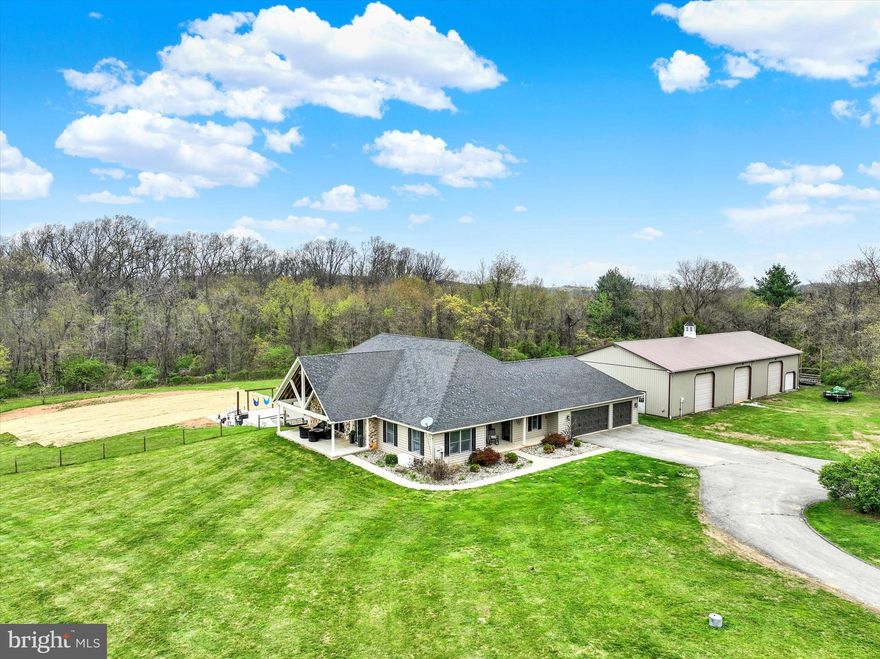 Welcome to 1685 Bahns Mill Road—an exceptional private estate set on 7.56 scenic acres in the Red Lion School District, where luxury living meets a true countryside retreat.

This expansive 4-bedroom, 3.5-bath home offers a thoughtfully designed open layout with soaring cathedral ceilings and a grand living room that creates an immediate sense of space and elegance. Hardwood floors flow throughout, complemented by fresh paint and new carpet, delivering a move-in ready experience.

The heart of the home is the beautifully appointed kitchen, featuring double ovens, a built-in wine refrigerator, and seamless access to the dining area—perfect for entertaining. A spacious sunroom with classic brick flooring offers year-round enjoyment and opens to the rear deck, blending indoor and outdoor living effortlessly.

The primary suite is a true retreat, complete with a private fireplace, walk-in closet, and direct deck access. The en-suite bath provides a spa-like experience, while additional bedrooms offer convenience with attached bath access and a versatile loft space overlooking the main living area.

The 3100+ square foot finished lower level is an entertainer’s dream—featuring a full bathroom, wet bar, wine room, fourth bedroom, and walk-out access to your private outdoor oasis.

Step outside to experience resort-style living: a 16x40 heated fiberglass, wood-burning saltwater pool, in-ground hot tub, and a one-of-a-kind Pizza Megadome—combining a wood-fired pool heater and pizza oven for unforgettable gatherings. A permanent outdoor grilling area and custom Key West-style swings create the ultimate setting for relaxation and entertaining.

For those seeking space and functionality, the property delivers with a 41x90 pole barn with three bay doors and 200-amp service, a 3-acre fenced pasture ideal for horses or livestock, and a dedicated chicken coop area complete with an automatic egg layer.

Major system upgrades provide added peace of mind, including a new roof, new HVAC system, and brand new water heater.

An improved 3-car attached garage and abundant storage throughout complete this remarkable offering.

This is more than a home—it’s a lifestyle. A rare opportunity to own a private estate designed for both everyday living and unforgettable entertaining.