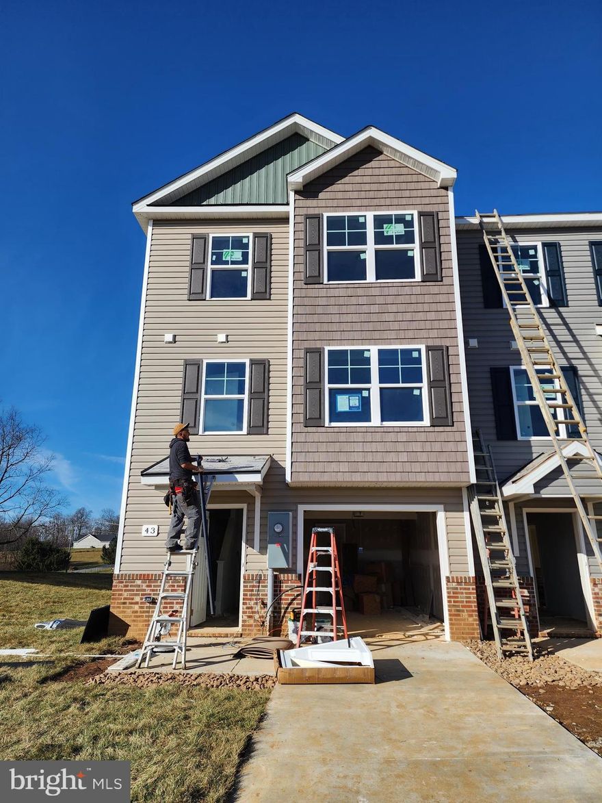 Pre-sales for October Delivery!
YOUR FIRST YEARS POWER BILL IS ON US!!!! Up to $10,000 closing cost assistance!!!
The Berkeley II Garage townhome pre-sales. Fall 2023 delivery. 
This end-unit 4 bedroom, 3.5 bath garage townhome has an open concept design on the main floor w/ a kitchen island with granite top, 42" cabinets, a high low peninsula with granite top for entertaining, stainless-steel appliances, a large living room w/ a bump out and a half bath. The upper level features a large primary bedroom w/ cathedral ceiling, walk-in closet, double vanity and a walk-in tile shower; two guest bedrooms, one of which has a 2-story bump out, full guest bathroom, linen closet and laundry. The lower levels feature a coat closet, foyer, single car garage w/ automatic garage door opener (app enabled also) and fourth bedroom with a full bath w/ door to access to your backyard, this room makes a great recreation room as well. There will be NO homes built behind you here!!! Throughout the home you will find recessed LED's, ceiling fans in the Primary bedroom & living room w/ each additional bedroom pre-wired for ceiling fans. High/Low outlets w/ pass through plates w/ CAT5/COAX/HDMI in Owner's bedroom & living room to make mounting your TV a breeze. You get more for your money with Four Points Construction. We are a featured loaded builder.  Winner of WV Best in Class for Energy Efficiency - The Communities of Burwell has done it again! Pictures are of similar construction townhome.