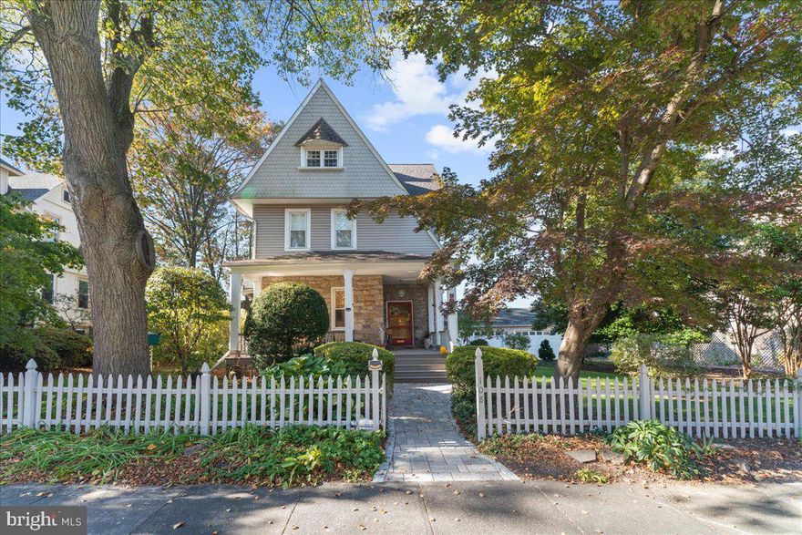 This uniquely restored and meticulously maintained Victorian home, with exceptional details, is set amid mature landscaping on an oversized lot and awaits a new owner who appreciates its incomparable features: a heated and air-conditioned four-car garage, an oversized driveway that accommodates multiple vehicles, a superb location, one block from Narberth’s welcoming assortment of shops and restaurants equal to urban amenities.  Captivating curb appeal will immediately entice you to walk through the picket fence gate, up the stone path bordered by azalea bushes to a covered front porch. You then enter the impressively large front door into a two-story foyer, adorned with a crystal chandelier, decorative fireplace, and stained-glass window. The foyer leads to the sundrenched living room illuminated with oversized windows that are framed with distinctive molding. Attractive bow windows overlooking the garden brighten the dining room which is enhanced with a stylish built-in China cabinet. Pocket doors allow you to seclude the dining room from the foyer and living room. The generously sized eat-in kitchen offers seating at the breakfast bar with additional room for a table and chairs. Generous counter space (all granite) and floor-to-ceiling cabinets offer ample prep and storage space. Two interior staircases, one from the foyer and the other from the kitchen, provide easy access to the second floor. From the foyer, ascend the open and airy Victorian staircase, enhanced by two large stained glass windows, to the second floor where you will find three bedrooms.  The primary bedroom features a large, walk-in, custom closet that used to be another bedroom.  The second and third bedrooms each overlook the garden. Two bathrooms (one combined with the laundry room) service the three bedrooms. The lovely staircase continues to a third floor with three additional bedrooms that can be also used as a home gym, an office, a playroom, a craft room, or an au pair suite along with a large storage room featuring a tall built-in storage cabinet. The attic, insulated for energy efficiency, is accessible from the third-floor full bathroom.  The home blends substantial modern conveniences with numerous antique features: an oversized, oak front door, 8 stained glass windows, wood floors throughout with decorative inlays in the foyer, living and dining rooms, 10-foot-high ceilings with oversized windows (first floor), an antique gas fireplace, and two claw-foot tubs. Extra storage is available in the unfinished basement with direct access from the kitchen and back yard. The grounds feature a white picket fence framing the front yard, adorned in the spring with daffodils and draped with clematis and roses throughout the summer.  More of the garden can be enjoyed from the front porch (think morning coffee, afternoon reading, and happy hour) which extends along the entire width of the house and wraps around to the front door.  Enjoy the garden from your hot tub in the seclusion of your back patio. A large, shady side yard is the perfect place for family activities or to relax in the garden’s serenity. Abundant flowers begin blooming in spring & continuing until the first frost! This coveted walkable neighborhood rarely sees a home offering so much that is also conveniently located to Narberth’s appealing downtown, including a short walk to SEPTA’s Regional Rail Line to Center City Philadelphia (3 stops to 30th Street Station) and Lower Merion’s award-winning schools.