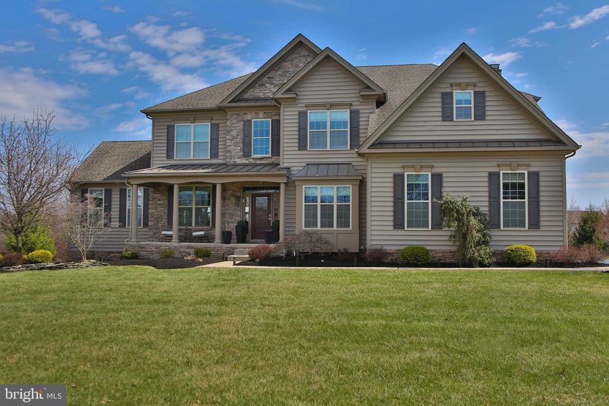 Welcome to 5800 Nash Dr, a 4-bedroom luxury estate nestled on 1.97 private acres in Plumstead Township. Thoughtfully designed with timeless architectural details, this residence seamlessly blends sophistication, comfort, and functionality. A charming front porch leads you into a dramatic two-story foyer where gleaming hardwood floors and a striking curved staircase create a grand first impression. To the right of the foyer, double doors open to a private office, perfect for remote work. To the left, the foyer flows into a formal living room that transitions seamlessly to an elegant dining room adorned with crown molding, chair rail, and a neutral palette ideal for entertaining. Just beyond the dining room, a sunlit conservatory offers a tranquil space to relax while enjoying picturesque views of the property. The gourmet kitchen is a chef's delight, featuring granite countertops, a double bowl sink, recessed lighting, and an expansive center island with breakfast bar seating. French doors lead to the rear deck and patio, perfect for outdoor dining and gatherings. The expansive two-story family room features coffered ceiling, a gas fireplace, and a secondary staircase to the upper level, creating a true heart-of-the-home gathering space. Completing the main floor are a powder room and laundry room, and easy access to the three-car side-entry garage. Upstairs, the luxurious primary suite includes a spacious bedroom with a sitting area, a large walk-in closet, and a spa-like en-suite bathroom with a soaking tub, tiled shower, and dual vanities. Two additional bedrooms share an adjoined bathroom, while a fourth bedroom features its own private en-suite bath, ensuring comfort and privacy for family or guests. The full unfinished basement offers incredible potential for additional living space, recreation, and/or storage.  Located in the highly sought after Award winning Central Bucks School District, this exceptional property is just minutes from Doylestown Borough, shopping, and dining.  This home combines luxury living with everyday convenience. Don’t miss out; schedule your showing today and experience the elegance of this remarkable home and neighborhood!