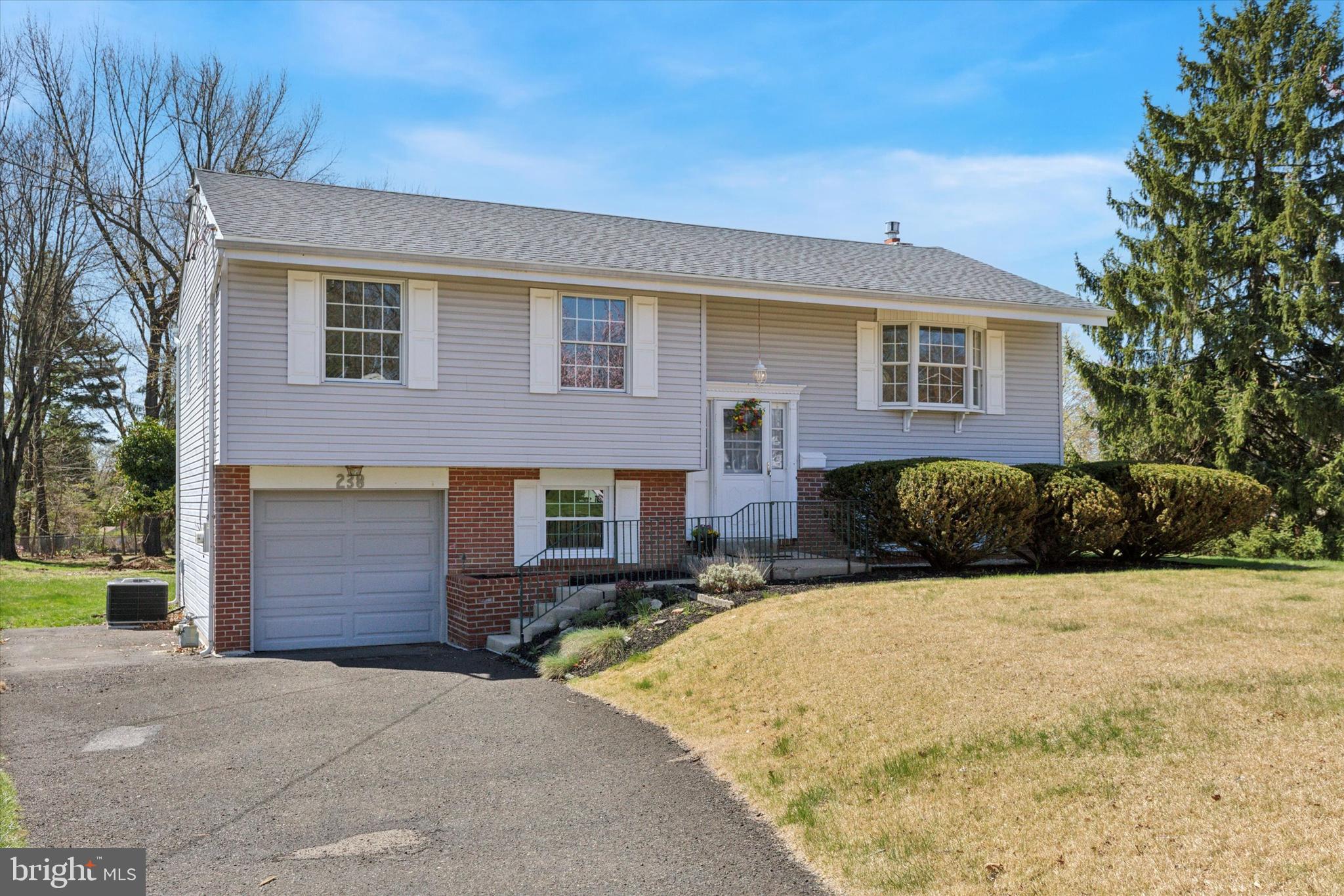 Welcome to 238 Colonial Drive! This lovingly maintained and move-in ready 4-bedroom, 2-bath bi-level home is perfect for families looking to settle in the heart of Warminster. Located on a spacious corner lot on a quiet dead-end street, it offers both safety and serenity—an ideal setting for kids to play and grow. Step inside and feel right at home with a freshly painted interior, updated kitchen with newer appliances, counters and custom backsplash. The home boasts two fully remodeled full bathrooms, and plenty of space for the whole family. The second floor features three bedrooms, remodeled bathroom, spacious living room and separate dining room as well as a well-appointed and updated kitchen. Hardwood floors on the second floor are protected by plush carpeting. The home includes family-friendly touches like a conveniently located laundry chute, a pull-down attic for additional storage, newer HVAC mechanicals, and a brand-new roof to add peace of mind. The lower level offers a fourth bedroom which can be used as an office, exercise or bonus room. The lower level boasts new Luxury Vinyl Plank Flooring throughout, a fully remodeled full bath with walk in shower and a large family room with a natural gas fireplace. An oversized door offers direct access to a rear concrete patio which is perfect for backyard barbecues and gatherings. The laundry and mechanical room is convenient and offers access to the 1-car garage. This fantastic home is located just minutes from local schools, Warminster Park, and shopping. Pride of ownership is evident throughout, and it's all ready for your family to move right in and start making memories. Make your appointment today! Open House this Sunday April 13 from 1:00 PM to 3:00 PM!