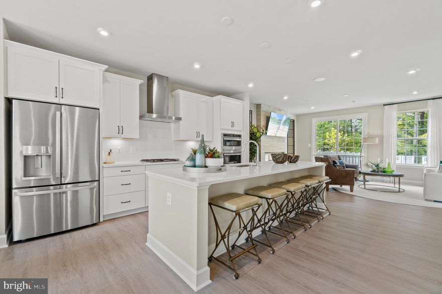 Experience high-end living in this interior townhome within the sought-after Marlboro Ridge community. The neighborhood offers a rich amenity program with a club house, pool, tennis courts, tot lots, equestrian center, equestrian and walking trails. The Bradbury is thoughtfully positioned, backing to a serene, wooded area, providing a sense of privacy and natural beauty. Boasting three bedrooms, two full baths, and three half baths, it's designed for modern comfort. The loft features a rooftop terrace, a unique space to enjoy outdoor moments and breathtaking views. Oak stairs add an elegant touch, and the gourmet kitchen with white cabinetry is a chef's dream. The finished lower level, complete with a walkout to the fully fenced rear yard, offers a seamless transition to outdoor living, creating a perfect haven for relaxation and entertainment.  This home is under construction and access is limited.  Please visit the onsite Sales Office for a tour.  Photos are of a similar home.