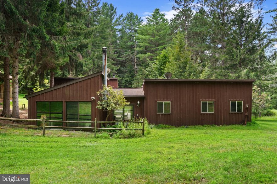 Welcome to 20 Lodge Circle!  Spacious and inviting, this 5-bedroom, 2-bath home offers an open-concept kitchen and family room with vaulted ceilings—perfect for gathering and entertaining. The home’s unique L-shape design provides privacy for the bedrooms while keeping the main living spaces light-filled and connected. Step outside to a large deck with a hot tub, or enjoy the detached garage for extra storage and parking.  Set on a rare, mostly flat and oversized lot in sought-after Sky Valley, this property stands out from the typical hillside, wooded parcels in the community. It offers plenty of space for outdoor games, barbecues, family reunions, small weddings, kiddie pools, swing sets, a fire pit, or a dog-friendly play area. You could even expand your outdoor living with a patio, kitchen, or fireplace. The setting is sunny yet private, with recent pine tree plantings adding natural beauty and future shade.  Residents of Sky Valley enjoy 3,000 feet of Deep Creek Lake frontage with a marina, 154 boat docks, launch ramp, lakeside canoe/kayak storage, sandy beach with swim floats, picnic areas, playground, basketball court, fishing pond with gazebo, sledding trails, and abundant wildlife. Community security cameras and quiet surroundings add peace of mind.  Fantastic value for a unique property offering both indoor comfort and exceptional outdoor space in one of Deep Creek’s most desirable lake-access communities!  Schedule your tour today!