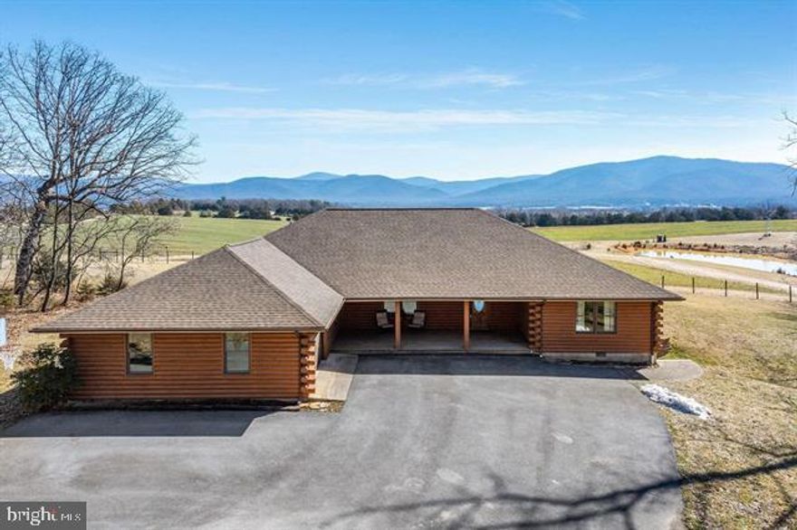 Magnificent log home situated on 2.6 acres with Million Dollar panoramic views of the Shenandoah Valley. If a superb view and settings what you desire, look no farther as settings and views like this don't come to market often. Featuring 3 main floor bedrooms and 2 spacious bathrooms, each room is adorned with large windows and glass doors to take in the panoramic valley views across the adjoining farmland and pond. If additional space to expand is desirable, the property features a 10x40 unfinished 2nd story for room to expand as well as a 600 sq ft basement room. The attached garage features a heated and cooled workshop area as well, great for a craft room or workshop. The wooded front yard provides for ample privacy and seclusion while the flat open side and rear yards provides great garden space and relaxation area by the existing fire pit. Located just minutes from Massanutten Resort, Merck, Coors and the Hospital this is a super location and must be seen to be appreciated.
