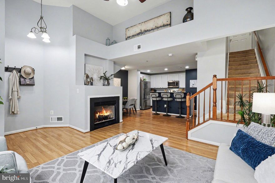 Dramatic ceiling heights and oversized windows fill this two-level townhome-style condo with natural light, making the home feel even more spacious than its footprint suggests. Laminate plank flooring and an open-concept main level create a comfortable living space with living, dining, and kitchen areas featuring white cabinetry, granite counters, and stainless steel appliances. A convenient half bath and attached garage complete the first level. Upstairs offers two bedrooms, two full baths, laundry, and a private balcony, providing a highly functional layout. The current owners replaced the AC and all appliances in recent years, and in 2025 the condo association installed brand-new windows throughout, improving energy efficiency and modern appeal.

Located in the Stone Ridge community, residents enjoy pools, tennis courts, sports fields, playgrounds, community centers, fitness facilities, and miles of trails. Conveniently positioned between South Riding, Arcola, Brambleton, Ashburn, and Sterling, with shopping, restaurants, wineries, and major commuter routes nearby.