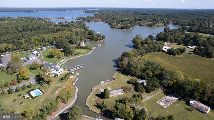 **Discover Your Waterfront Oasis in Royal Oak**

Nestled in the charming town of Royal Oak, these exceptional waterfront properties present breathtaking views of Oak Creek, conveniently located near the Miles River and the renowned Chesapeake Bay. Positioned between the picturesque communities of Saint Michael’s and Easton, this rare gem boasts approximately 541 feet of pristine water frontage, enhanced by a newly installed bulkhead as of summer 2025.

Comprising two distinct parcels, both properties offer expansive water vistas that are truly captivating. Imagine enjoying serene afternoons by one of the two existing pools, each perfectly situated to overlook the tranquil waters.

Each home is equipped with its own dedicated well and is connected to public sewer, ensuring convenience and reliability. Elevated above flood risks, this property requires no flood insurance, providing peace of mind for future owners.

The first residence, a charming brick rancher at 7049 Acorn Alley, features single-story living with three bedrooms and 1.5 baths, set on a generous .81 acres. Built in 1963, it offers 1,454 square feet of cozy, inviting space.

Across the way, the colonial-style home at 7047 Acorn Alley boasts four bedrooms and two full baths, nestled on .73 acres. Constructed in 1975, this expansive 1,920-square-foot residence provides ample room for family gatherings and entertaining.

Ideal for outdoor enthusiasts, this location is a paradise for boating, fishing, kayaking, and paddle boarding, with calm waterways that invite exploration. The property is also perfect for bird watching and cycling, making it an ideal haven for nature lovers.

Whether you envision a lucrative investment, a serene vacation retreat, or the canvas for your dream home, the endless possibilities await. Centrally located in Talbot County, with easy access to Easton, Baltimore, and the DC metro area, as well as a short ferry ride to Oxford, this property is a unique opportunity not to be missed. Embrace the lifestyle you've always desired and make this waterfront paradise your own.