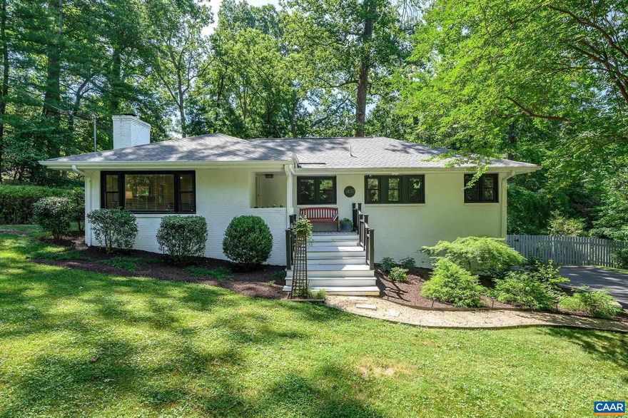 Wonderful renovated mid-century modern brick home located on a quiet tree-lined street in Greenbrier, walkable to neighborhood schools, and convenient to Downtown Cville, UVA, and the 29/250 corridors.  Since purchasing in 2012 owners have revamped nearly every inch of this property including installing new windows, roof and HVAC, updating kitchen and hall bath, adding a welcoming front porch, and completely transforming the fenced rear yard into an oasis of mature plantings, stone walls, and a private patio for enjoying the natural park-like setting.  Main level features hardwood flooring throughout (except for kitchen and baths), cozy woodburning fireplace in the living room, and a great open floor plan.  The basement includes a spacious family room with new carpet, full bathroom, home office, laundry, loads of storage, and a 2 car garage, a very rare feature in a house of this vintage!   Greenbrier has sidewalks throughout and is just steps from Meadow Creek Park and the Rivanna Trail.  A fantastic home in one of the prettiest neighborhoods in Charlottesville!,Painted Cabinets,Quartz Counter,Wood Cabinets,Fireplace in Living Room