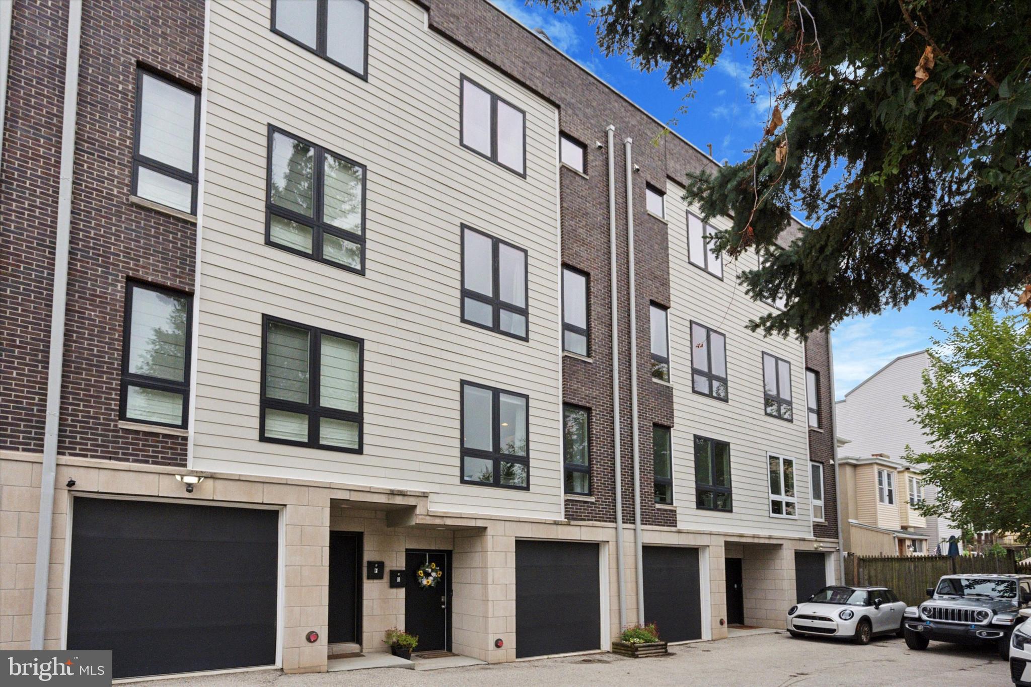 This property offers a free 1% Rate Reduction for the first year at no cost to the buyer when using seller's preferred lender (Movement Mortgage). Welcome to 3831 Terrace St #G – a beautifully maintained townhouse in the heart of Manayunk, featuring 4 bedrooms, 3.5 bathrooms, 2-car parking, and elegant luxury finishes throughout. This home boasts over 3,000 sq ft of modern living space with an open concept main floor, gleaming hardwood floors, oversized windows, abundant closet space, high-end bathroom finishes, and one year remaining on the 10-year property tax abatement.
The main level is bright and open with floor-to-ceiling west-facing windows, a dining area, and a spacious living room that opens to a private front porch. The recently updated kitchen features white shaker cabinets, a center island with seating, quartz countertops, stainless steel appliances (refrigerator, gas range, range hood, microwave drawer, dishwasher, and wine fridge), a pantry, under-cabinet lighting, and sleek black fixtures.
Upstairs, you’ll find two large bedrooms including a guest suite with en-suite bath, an additional hall full bath, laundry area, and storage.
The 3rd floor master suite is a true retreat with a private balcony, expansive walk-in closet, and a spa-inspired bathroom featuring a freestanding soaking tub, oversized step-in shower, Porcelanosa double vanity, and separate water closet. A pilot house opens to a spectacular two-sided roof deck, offering skyline views and breathtaking sunsets to the west, while an east-facing space provides the perfect setting for entertaining. A custom wet bar with sleek quartz countertops enhances the experience, making rooftop gatherings effortless.
The lower level offers a fourth bedroom or flex space—perfect for a home office, gym, media room, or guest quarters. Parking is easy with a 1-car attached garage and an assigned off-street space. The garage is equipped with a 208-volt outlet and a 50-amp breaker, perfect for charging your electric vehicle.
Located on a quiet side street just steps from Main Street Manayunk, regional rail, major highways, Kelly Drive, Center City, the suburbs, and multiple parks and trails.