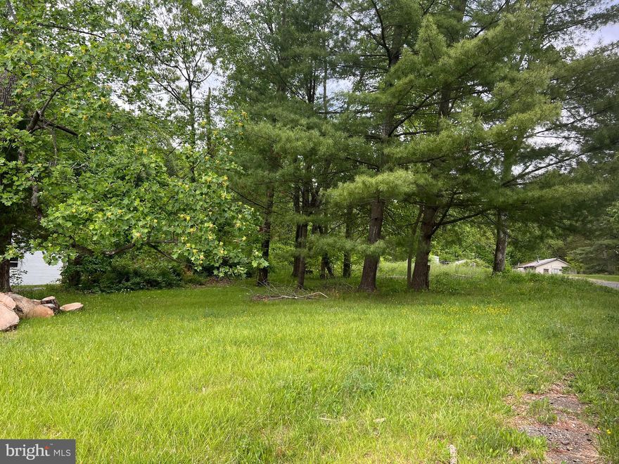 1 acre lot. Enter on grade. Rises slightly. Some large trees. Backs to woods. No builder tie in. Please call for appointments. Appraisal is available upon request. Country Road location. Farms and Single Family homes.