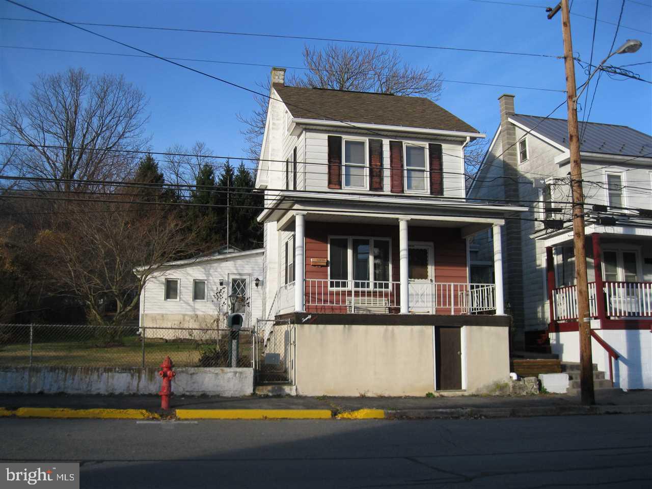 2 Story home. Living room and kitchen has oak cabinetry and a large space for dining at the bar area. 1 full bath, washer and dryer on the first level. Second level has 2 bedrooms and walk-up attic. Detached 2 car garage. There is another parcel that includes a basketball court area and a pavilion.