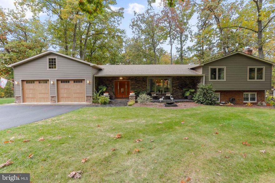 Prepare to fall in love with this entertainer's paradise! Situated on a spacious tree-lined corner lot in a quiet community, this stunning split level home offers great curb appeal and leaves you anxious to see what awaits inside. Step into the expansive open concept living area featuring soaring cathedral ceilings and gleaming Argentinian Oak flooring flowing seamlessly throughout. Your inviting great room offers a stone surround gas fireplace and access to the refinished rear deck. Your inner chef will be delighted by the gourmet kitchen which boasts an oversized island/breakfast bar with soft close doors, gorgeous granite counters, ample cabinet space and stainless steel appliances including a gas cooktop, wall oven and dual purpose microwave.  A large picture window and skylights that easily open allow plenty of natural light inside.  Completing the main level is the beautiful addition consisting of a mud room, full bath with roman shower and the laundry room with built-in cabinetry with an apron sink and the front loading, large capacity washer and dryer The upper floor hosts all three bedrooms along with the primary bath and full hall bath which were both remodeled in 2008. Additional space awaits in the finished lower level which hosts a family room with a wood burning fireplace and an office, ideal for working from home. The sprawling rear lawn backs to mature trees and offers a gazebo and a fenced in portion which is great for your pets. The gazebo is connected to the built-in indoor/outdoor Bose sound system, making entertaining a breeze. Storage is not an issue with the insulated loft space in the oversized 2 car garage and a large storage shed. Additional highlights include the hot tub and top of the line Napoleon gas grill which will convey, a new roof and windows along with dual heaters and water heaters for each side of the home which really help keep energy costs low. Offering close proximity to highways, shopping and dining, this fantastic home checks all the boxes!