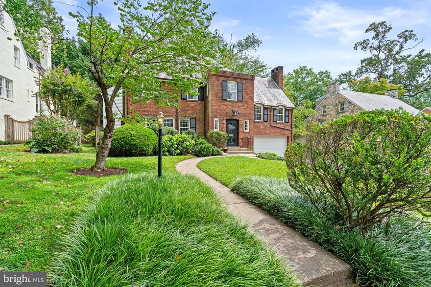 This beautiful red brick residence is ideally located in the heart of Spring Valley on over a quarter acre lot. Originally built in 1939, this lovely home has been seamlessly expanded to include over 5,600 square feet of exceptionally maintained interior living space. The house features a highly desirable floor plan with generous formal rooms and comfortable family living spaces. There are lovely hardwood floors, elegant crown moldings, and oversized windows, providing spectacular natural sunlight throughout. The main level offers a welcoming foyer with a gracious flow to the attractive living room. The living room has three large windows and a wood-burning fireplace. It neighbors the sophisticated dining room, which has convenient swinging doors to both the kitchen on one side and the family room on the other. The gourmet chef’s kitchen features stainless steel appliances, a large center island with breakfast bar seating, and abundant cabinetry storage. There is also an adjoining breakfast room with a built-in desk, window seats with storage, and glass paneled doors to the rear deck and yard. French doors lead to the generously-scaled family room, which also accesses the backyard. There is the added convenience of a powder room and coat closet on this floor. The second level has five bedrooms and three bathrooms, including the well-appointed primary suite. The primary bedroom has a soaring Cathedral ceiling and has a private sitting room/office, a large walk-in closet, and an en-suite bathroom. All additional bedrooms on this floor are spacious and light-filled. The third floor offers a large finished attic space with multiple closets for additional storage. The lower level of the residence offers a large recreation room with a fireplace, a laundry room, bathroom, and multiple storage rooms. The exterior of the residence is exceptionally private. The fully fenced rear yard is flat with mature trees and beautiful landscaping. There is an expansive deck with multiple seating areas for outdoor dining and entertaining. There is also a one-car garage and driveway parking. This exceptional residence is located within close proximity to neighborhood favorite restaurants, shops, and parks.