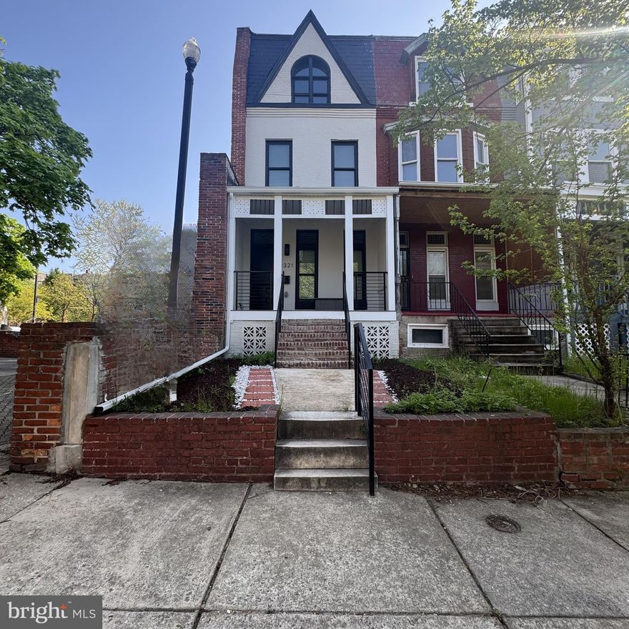 An elegant transformation has taken place behind the door of this 4BR/3BA end of row Townhome, located in the desirable neighborhood of Reservoir Hill. Make your way to the covered front porch featuring new railings, Trex decking, and the front door into your new home.  Step inside to four floors of glamorous living space, tons of natural light, luxury flooring throughout, and recessed lighting.  The main floor living space offers a large living room with a custom feature wall and original transom windows, a spacious dining room, a stunningly designed kitchen, and a bonus room.  The kitchen boasts mixed metals featuring gold, black and stainless throughout, plenty of cabinets, sleek quartz countertops with a complimenting tile backsplash to the ceiling, stainless steel appliances including a slide-in electric range, a deep stainless sink set into an island with breakfast seating and glamorous pendant lights above. Tucked behind the kitchen is a cozy family room with an electric fireplace feature and access to the fenced yard.  On the second floor is a spacious secondary bedroom, a larger primary bedroom, and a newly remodeled full bath featuring a beautifully tiled walk-in shower.  On the third floor are two sizable secondary bedrooms, and a full bath with a deep tub and tile from ceiling to tub.  The lower level is finished offering additional living space with a full bath featuring tiled walk-in shower, a spacious recreation room with a faux fireplace, laundry and storage. From the main floor step outside to a deck that overlooks a yard offering a newly constructed walkway, green space, and beyond the fence a concrete parking pad.  This home is move-in ready with so much to offer new homeowners, offering access to a community space just steps from your front door, and is nearby shopping, restaurants, and commuter routes.