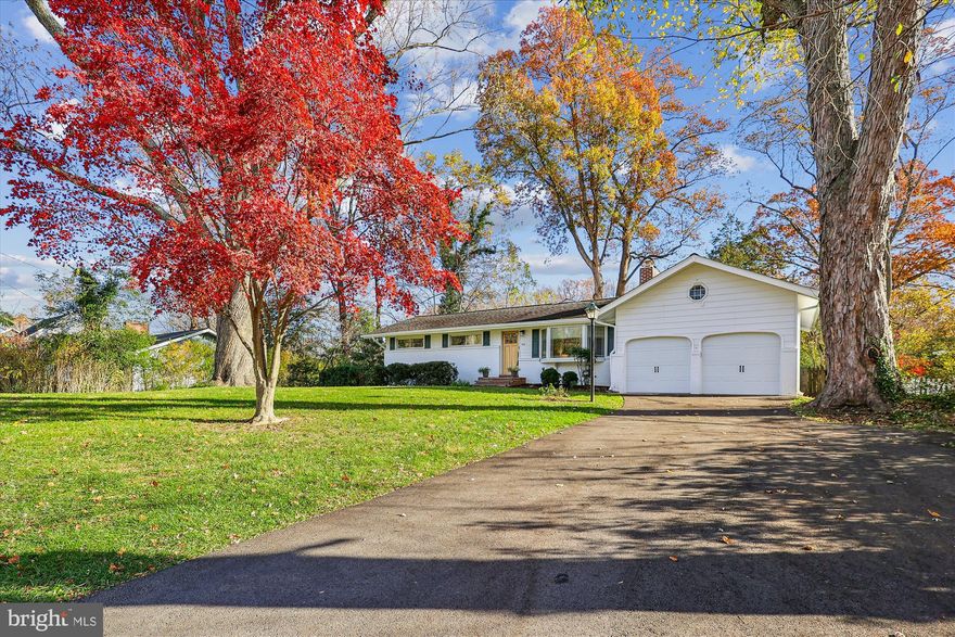 The perfect blend of 1950s charm and modern Annapolis living, situated steps from the water and an easy walk or bike ride across the Naval Academy Bridge to West Annapolis and the historic downtown area. This classic Pendennis Mount ranch-style home, built in 1959, has been beautifully updated. Step inside to find the home's original character with hardwood floors, now opened up into a generous main living and dining area. The real showstopper is the expansive rear kitchen addition featuring vaulted ceilings, huge windows overlooking the backyard, and a chef's setup: granite countertops, stainless steel appliances, a gas cooktop, and a large walk-in pantry.  The main level hosts 3 bedrooms and a full bath, while the finished lower level provides excellent flexibility with a large den, 2 additional bedrooms, a kitchenette, and bonus room with french doors that open to a patio—perfect for a guest suite or entertaining space. You’ll also appreciate the two-car attached garage with extra storage space for a workshop or whatever your needs may be. The driveway was freshly paved last year. Situated on a spacious, fully fenced 0.34-acre lot with mature trees, this property offers rare privacy and two patios. Enjoy the quiet, safe streets of the highly desirable Pendennis Mount community featuring a newly renovated community playground. You are minutes away from Jonas Green Park. Commuting is convenient with swift access to routes toward Baltimore and Washington D.C.