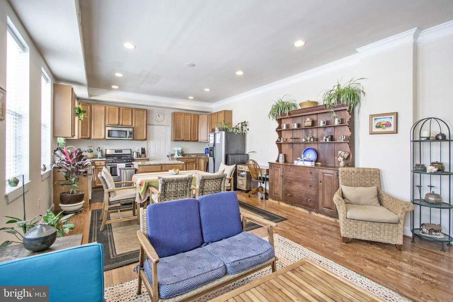 This residence boasts three bedrooms, two full bathrooms, and a laundry area on the upper level. The main floor features an open and bright layout with high ceilings and hardwood flooring. The kitchen is expansive, equipped with a central island and a gas stove. The top floor is fully finished, offering a flexible space ideal for a home office, playroom, or guest room, as well as additional storage. The property extends close to 2,000 sq ft over three floors and includes a fenced backyard and side yard, off-street parking, and is near Lynhaven Park. There's a playground just across the street, and Cora Kelly Elementary is a short walk away. The home is also within walking distance to Potomac Yards, the metro station, and is under a mile from the lively Del Ray neighborhood.