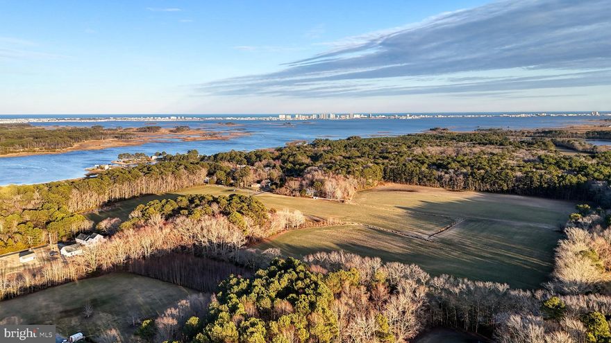 Discover an extraordinary opportunity to own 47.11 acres of prime waterfront land overlooking Grey's Creek with breathtaking views of the Ocean City skyline. This expansive property offers a rare blend of serene natural beauty and captivating coastal scenery, making it an ideal canvas for your vision.

Nestled along the tranquil shores of Grey's Creek, the property boasts a picturesque setting where winding waterways meet vast open skies. Imagine waking up to the gentle sounds of the creek, with panoramic views that stretch to the vibrant lights of Ocean City in the distance. While the land is currently raw with no site plan in place, it is positioned between established high-end subdivisions, presenting an exceptional opportunity for development or investment.

Most of the property is cleared and is divided by a quiet country road. The waterfront section features large trees that are protected by a conservation easement and subject to critical area restrictions, ensuring the preservation of this natural beauty.

Whether you envision a private estate, a recreational retreat, or a future community, this remarkable parcel provides endless potential. With ample acreage, direct water access, and proximity to coastal attractions, this property invites you to embrace the best of waterfront living. Don’t miss this chance to own a piece of Maryland's Eastern Shore paradise – where nature's beauty meets the charm of coastal life.