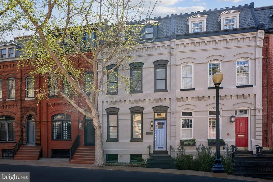 NEW ON SWANN STREET WITH PARKING & ROOFTOP DECK! New HVAC for Upper Levels. Welcome to 1526 Swann Street, a beautifully updated and turnkey residence, nestled along one of DC’s most coveted and captivating tree-lined streets. This spectacular residence boasts 5 Bedrooms, 4.5 Bathrooms and nearly 2,900 square feet across 4 levels of living space with wood floors and crown moulding throughout. Step inside and embrace the exquisitely designed open concept floorplan that features separate Living and Dining Spaces, a gourmet Kitchen, Powder Room and private deck, perfect for entertaining on Spring and Summer nights. The gourmet Kitchen is a showstopper, featuring top-of-the-line Wolf and Subzero appliance packages, new beverage refrigerator, two tone cabinetry, designer lighting and expansive rectangular picture window overlooking the scenic climbing ivy that lies ahead. Upper Level 1 is home to the Primary Suite and a second Bedroom and Bathroom. The Primary Suite features large windows affording an abundance of natural light throughout, sizeable walk-in dressing closet, and luxurious Primary Bathroom with marble tile, dual vanity sinks, glass enclosed rainfall shower and spa-like freestanding bathing tub. The top floor features 5 skylights atop 2 additional Bedrooms and a Bathroom. The Rooftop deck is also accessible from this level with recently added gas line and gorgeous views of the neighborhood, including the picturesque Scottish Rite House of The Temple. The lower level of this home features an in-law / au pair suite with large Rec Room, wet bar, second set of laundry, Bedroom and Bathroom with outside access. Situated only two blocks away from DC’s thriving 14th Street Corridor, the location is simply perfect. Enjoy an easy commute by foot or car to downtown offices, the White House, and metro lines. Don’t miss out on this turnkey opportunity to experience city living at its finest.