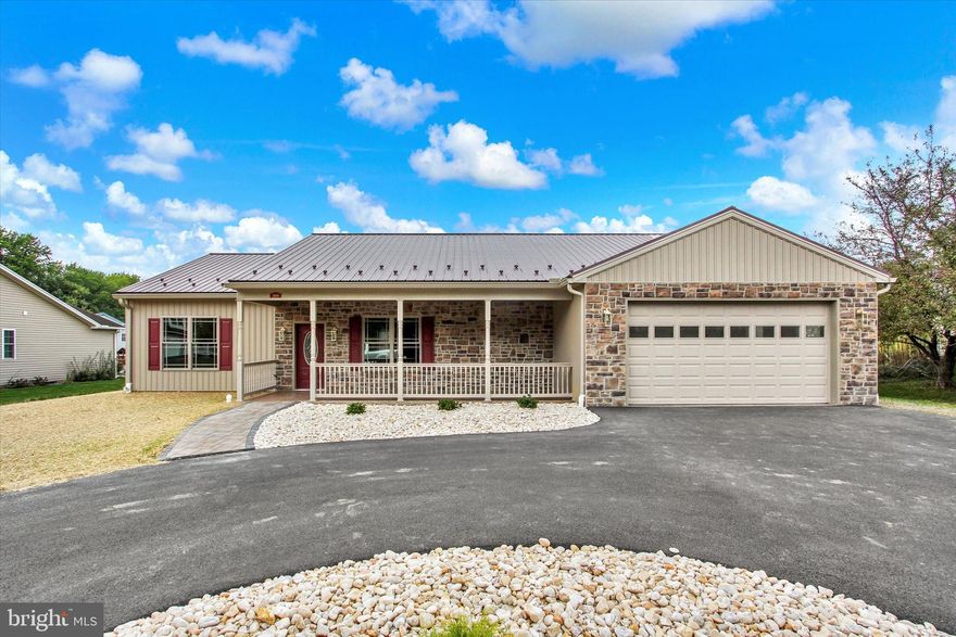 NO steps into this brand-new, modern rancher nestled in a desirable, established neighborhood with no HOA! The inviting open floor plan features durable LVP flooring and vaulted ceilings, creating a bright and airy feel. At the heart of the living space is a stunning stone fireplace with a rustic wood mantel, perfect for cozy evenings. The contemporary kitchen boasts two-tone cabinetry—crisp white uppers and sage green lowers—and a walk-in pantry with custom shelving. Stainless steel appliances and sleek fixtures complete the space. This home offers three bedrooms and two full bathrooms, including a primary suite with a spacious walk-in closet and a beautifully tiled ensuite. Each bedroom has custom closet solutions. The oversized two-car garage provides plenty of space for vehicles and storage. Outside, you'll find a welcoming front porch with a stone facade and a metal roof, adding to the home's charming curb appeal. This property is the perfect blend of modern comfort and classic style. Tax assessment is from previous building, a new assessment has not been completed.  Tax amounts may change when a new assessment is completed.