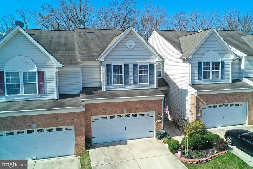 STUNNING was what the previous owner said and that is still the case for this owner.  A townhome that has everything you could possibly want.  First floor with soaring ceilings, two story stone fireplace and all with a contemporary flair.  Beautiful hardwood floors throughout first floor, kitchen with upgraded new stainless steel appliances.  Custom blinds throughout.  Tinted sliders to TREX deck with lighting, eat in kitchen with island and granite countertops.  Powder room and access to two car garage with professional epoxy flooring.  Lower level clubroom & sitting area with built in wet bar, cabinets, wine refrigerator and rack.  Full bath and storage room completes the Lower Level.  Sliders to large extended and professionally paved patio with fire pit.  Three bedrooms, 2 full baths on second level with washer and dryer area and overlook to first floor.  This home backs up to the woods and the Seven Trails walking path.  Absolutely gorgeous!!