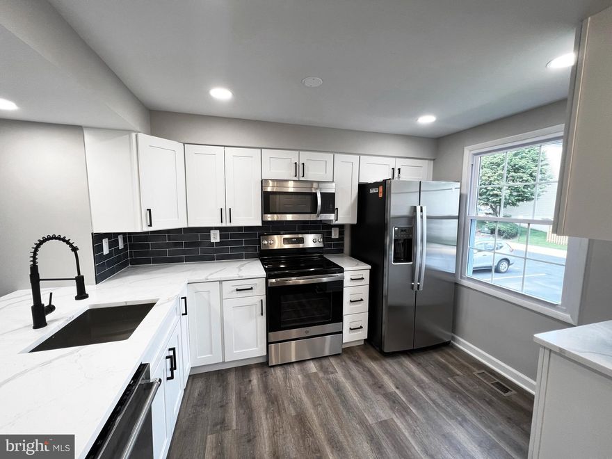 Absolutely STUNNING Townhome in the desirable Oak springs neighborhood.  Featuring fresh designer interior; open floor plan complimented by tons of Natural light, all new flooring, Energy efficient windows, upgraded kitchen with Shaker cabinets, Quartz counter , custom back-splash, and all new GE Stainless Steel Appliances; Lux bathrooms; custom fixtures; custom 2-tone designer paint throughout; and list goes on. Main living area open to large rear deck  overlooking fully fenced backyard - perfect for outdoor entertainment.  Additional Rec  room in basement with full bathroom. Prime location close to restaurants, shopping, and major commuter routes, , Perfect 10! You won't want to miss it!