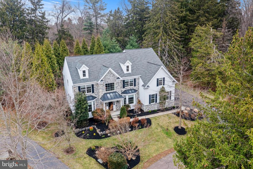 Welcome to 14 Dever Dr, in desirable Estates at Mill Creek.  This exquisite home boasts over 4,400 sq ft of finished living space that has been elegantly appointed throughout.  Custom finishes have been chosen for every square inch of this timeless and impeccably designed home.  Dramatic 2-story foyer with turned staircase and custom moldings greet you as you enter.  Custom hickory hardwood floors carry throughout the main level.  The foyer is flanked by a professional office and Formal Living Room.  Formal Dining Room overlooks the private rear yard and leads to the gourmet Kitchen with large center island, double ovens, 5-burner gas grill, high-end stainless appliances, Breakfast Room, custom coffee bar and open views of the expansive Family Room.  Elegant 2-story Family Room provides ample space for entertaining with cozy gas fireplace and views of the private rear patio and professional landscaping.  A custom-built mudroom, Powder Room and 3-car garage complete this level.  Upstairs, a Primary Suite creates your own private sanctuary with sitting room, tray ceiling and spa-like full bath.  Guest bedroom is en-suite with it's own Full Bath.  2 additional spacious bedrooms share a Center Hall bath.  A dedicated Laundry Room completes this level.  Magazine-quality finished lower level is sure to impress with a Theater Room, 2nd Family Room/Dining Room and Full Bar that is perfect for entertaining!  Rarely do homes in this pristine condition become available.  So much to offer on a quiet street and private lot encompassed by HOA protected space. Amazing location just minutes to Wegman's, Costco and all major routes in award-winning West Chester School District.  This magnificent home is sure to impress!