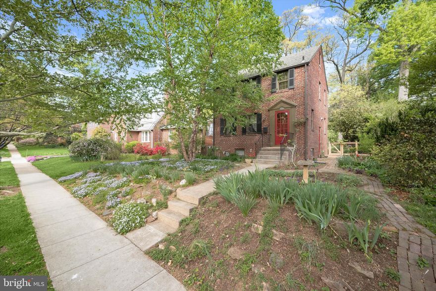 This charming 1940s brick Colonial in highly desirable University Park seamlessly blends timeless character with modern updates. Set on a beautifully landscaped, magnificently private 0.25-acre lot, this inviting residence offers approximately 1,760 square feet of thoughtfully designed living space, featuring four bedrooms and two full bathrooms. Inside, gleaming hardwood floors, elegant trim work, and refined architectural details create a warm and welcoming atmosphere throughout. The living room is the heart of the home, showcasing high ceilings, rich hardwood flooring, and a classic brick surround wood-burning fireplace, with direct access to a delightful three-season sunroom adorned with beadboard wainscoting, crown molding, and exposed brick accents. The dining room, ideally situated off the kitchen, provides a perfect setting for both everyday living and entertaining. The well-appointed kitchen combines style and function, with open shelving, a farmhouse sink, and butcher block countertops. The upper level features a serene primary bedroom with hardwood flooring, a neutral palette, and a spacious cedar closet, along with two additional bedrooms and a full bath complete with subway tile accents and blinds, and a linen closet. The fully finished lower level provides exceptional versatility, featuring a kitchen area, bedroom, full bath, and ample storage. With a private side entrance, this space is ideal for guests, multigenerational living, or income-generating rental. Outdoors, the tranquil backyard serves as a private retreat with a charming brick patio, stone walls and paths, flourishing gardens containing dozens of native tree and plant species, and a detached garage. Located within a mile of the University of Maryland, this home is also ideally situated for commuting, within easy walking or biking/bikeshare distance of the Green Line, Purple Line, and MARC Camden Line as well as major commuter routes including US-1, I-95, and I-495. The lively Route 1 Corridor and Hyattsville Arts District nearby offer shopping, dining, and entertainment ranging from Whole Foods and Trader Joe’s to Franklin’s Brewery and the Pyramid Arts Center. The Town of University Park greenspace affords quiet walking trails and playgrounds, and the nearby Anacostia Trails system features miles of walking/running/biking paths. A rare opportunity to own a home where classic charm, comfort, and convenience come together beautifully.