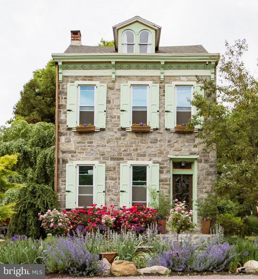 Welcome to this captivating c.1800 stone farmette, where timeless charm meets colorful garden splendor. Tucked away on 1.3 beautifully landscaped acres, this one-of-a-kind property offers a soul-soothing escape in a storybook setting.
Inside, the home features a bright and airy layout with exposed beams, wide plank floors, and a dramatic stone fireplace anchoring the main living space. The original dining room and parlor retain their historic character, while a private in-law suite with a large bedroom and full bath on the first floor adds flexibility for extended family or guests. Two additional bedrooms grace the second floor, with a fully finished third floor offering charming sleeping quarters under the eaves.
Garden lovers will fall head over heels, this property boasts the most vibrant, lovingly curated flower beds you’ll see. A stone pathway winds alongside the home through blooming borders, leading to a sunny back patio surrounded by lush plantings and bursts of color in every direction.
Out back, the c.1900 stone-and-frame bank barn retains classic architectural details, with original beams, footholds, and stalls intact. The lower level is well preserved and functional, while the main floor offers tremendous storage or creative space. A chicken coop, currently home to hens and a proud rooster, and a root cellar add to the property's rustic charm.
Though no longer standing, the original blacksmith shop's stone foundation remains at the edge of the lot, echoing the rich past of this early homestead. Recent updates include a newer roof and modern heating system, blending comfort with history.
This property offers peace, beauty, and a deep sense of place, perfect for anyone looking to slow down and enjoy the simple, meaningful pleasures of country life.