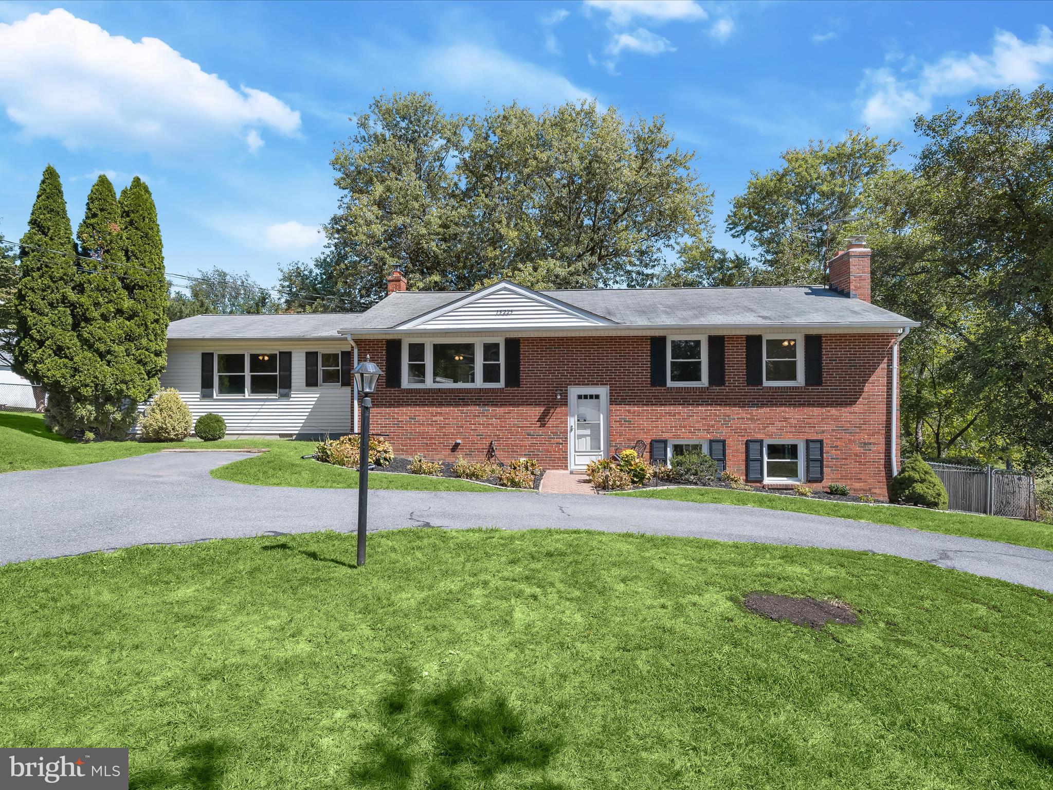 Beautiful brick-front split-level home combines modern updates with a flexible floor plan in a setting that feels both private and connected. A U-shaped driveway welcomes you, while freshly painted neutral colors and luxury vinyl plank flooring extend a warm and stylish touch throughout the interior.
The living room, highlighted by a picture window, flows into the dining room for an easy gathering space. The kitchen offers white 42-inch cabinetry, stainless steel appliances including a gas range that were replaced within the last several years, and plenty of storage. An addition creates a spacious primary suite retreat with three closets including a walk-in and a full bath featuring new marble tile flooring. On the other side of the home are three additional bedrooms, one with an attached half bath and direct access to a shared full bath with a shower, providing both convenience and privacy. The lower level offers abundant living space with a family room centered around a brick-front fireplace and built-in bookcases, as well as a full bath. A walkout leads to a patio, while a versatile bonus room can serve as a home office, hobby area, or exercise room. This level also connects to the utility room, where the washer and dryer replaced about a year ago are located. Outdoor living is just as appealing, with a screened porch featuring a cathedral ceiling, a storage shed with ramp, double doors, and two access points, and an expansive backyard that backs to trees. The property is surrounded by parkland on two sides, enhancing the sense of peace and privacy. A notable feature includes a generator that helps power the well, septic, and furnace. The water heater, oil tank, and electrical panel were replaced in the last five years.
Everyday conveniences are close at hand with the post office across the street and a country store for daily necessities. Outdoor enthusiasts will appreciate nearby Black Hills Park and Little Seneca Lake for water activities, along with a local farmers market. Commuters will benefit from a MARC train station nearby, while the home’s location on a state road ensures timely snow plowing in the winter. Blending thoughtful updates, flexible living spaces, and a serene setting close to everyday conveniences, this home offers the perfect balance of comfort, function, and location.