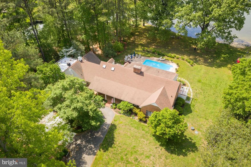 Just minutes to historic downtown Easton this Tred Avon River estate has it all.  Located in the rarely available Waverly Island neighborhood, the lushly landscaped, highly elevated, park-like lot is improved by an impeccably maintained and well appointed 4 bedroom home.  The features check every must have box including waterside pool, high speed internet, geo-thermal HVAC, huge waterview screened porch, main-level primary suite with private sunroom, and one of a kind frontage on a boat basin that is properly equipped with boat and jet ski lifts.