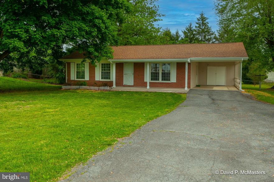 Welcome to this charming rancher, tucked down a peaceful side street of Bunker Hill, WV.  As you approach, you’ll notice the large shade trees, brick front, covered front porch, and car port, creating character and curb appeal. 
Inside, the open floorplan creates an inviting atmosphere, connecting the living room to the kitchen and dining area.  There are three bedrooms in total, full bathroom, and half bath with laundry appliances located off the primary bedroom. 
New laminate flooring, fresh paint, new kitchen appliances, and remodeled bathrooms add to the shine and interior appeal. 
Exterior updates include new gutters, paint and deck floor.
Enjoy barbeques from the rear deck, overlooking the quiet, flat rear yard, complete with a locked shed.  Perfect for outdoor games, gardening, and relaxation.  
This home is easy to access conveniently located close to schools and major highways.
This cute as a button find won’t last long, schedule your visit today!