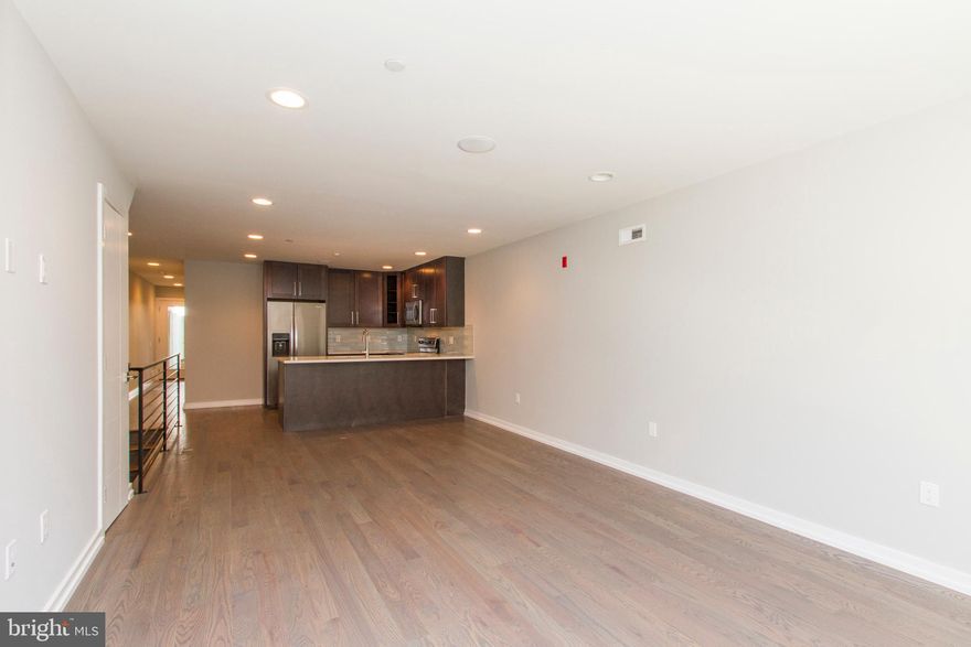 A gorgeous, newer construction unit that's ready and waiting to be called home! Enter this bi level unit and discover the hardwood flooring, recessed lighting, high ceilings with installed speakers, and large energy efficient windows which provide ample natural light. The spacious, open living and dining space offers plenty of room for entertaining friends and family, and showcases the gorgeous kitchen, which includes granite counters and large island, stainless steel appliances, and a beautifully tiled backsplash. Continue past the kitchen to find the beautifully tiled bathroom with tub and shower combo, and separate stall shower with frameless glass enclosure, both with dual shower heads. The floor also includes a sun drenched bedroom with a walk in closet and access to a patio- just the spot for lounging on those sunny days! Downstairs features two lovely ensuite bedrooms with custom tiled bathrooms and stall showers with frameless glass enclosures. Washer and dryer are included in the unit, as well as an installed security system, and the location can't be beat- close to shops, restaurants, not to mention just minutes away from Center City. Don't wait, see this unit today!