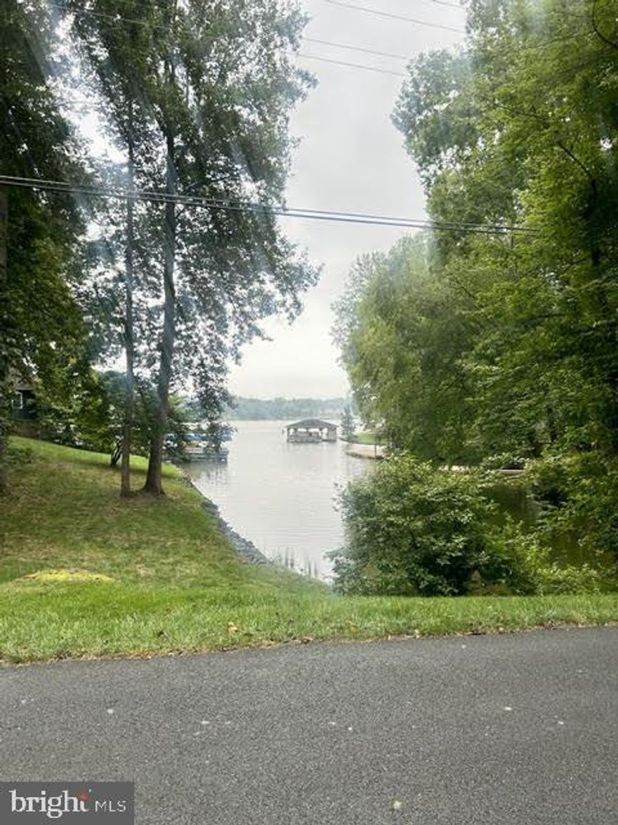 Come live the lake life at Blue Ridge Shores! Two lots merged into one, offering frontage on Beech & N. Lakeshore with an amazing view of a quiet lake cove.  Located in a gated lakefront community centered around a private 325-acre lake, you'll enjoy year-round recreation including boating, swimming, fishing, kayaking, and waterskiing (jet skis not permitted).
Blue Ridge Shores offers a welcoming lifestyle with multiple beaches, walking trails, tennis and basketball courts, playgrounds, picnic areas, and assigned boat slips. Family-friendly community events are planned regularly, creating a true sense of connection among neighbors. High-speed Xfinity internet is available, making remote work a breeze. Just 15 minutes to the Town of Louisa and convenient to both Richmond and Charlottesville. Bring your builder and your vision—your lake lifestyle awaits!