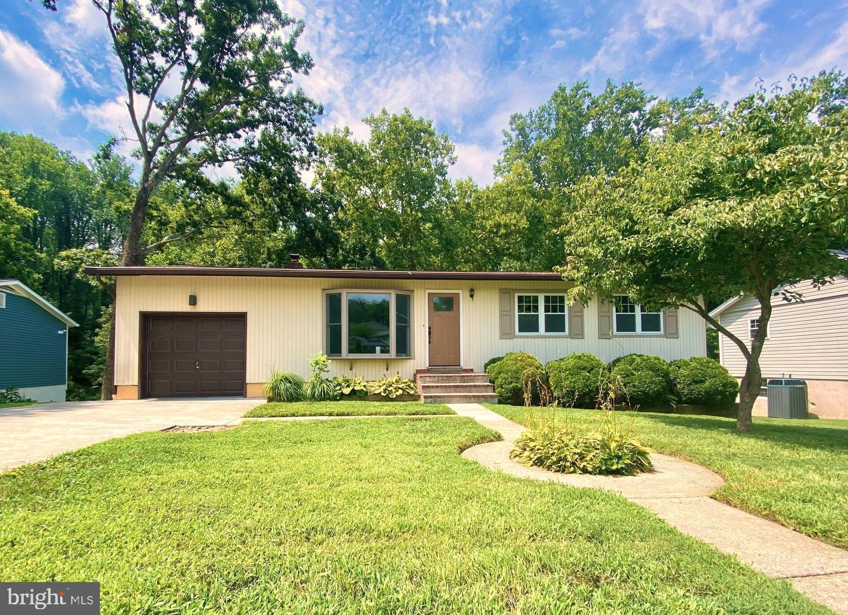 Beautiful raised ranch home in a sought after community. Light and bright and VERY clean! Bamboo floors on upper level and a big sunny bay window in the living room. New upper level full bath, upper and lower decks, fresh paint throughout. Primary bedroom has its own private bath. Lower walk out level basement offers new plush grey carpets, recessed lights, brick fireplace (decorative only) laundry room, 4th bedroom or office space with ceramic floors & full bath. Huge finished family room can also be used ad a lower level primary bedroom. Walk out daylight basement. Big back yard and backs to woods. Extra deep one car garage with extra wide 2 car parking pad. New landscaping. Non-smoking & NO PETS home. Broadneck schools. Great central location. Minutes to all major routes and Annapolis. 25 mins to NSA /Ft. Meade and BWI International Airport, 40 minutes to Baltimore, DC.