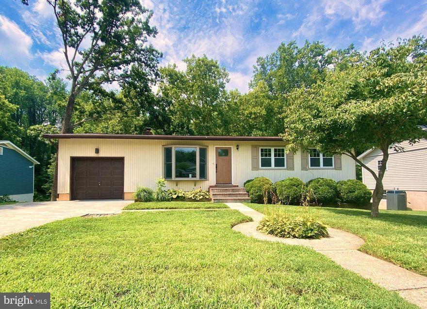 Beautiful raised ranch home in a sought after community. Light and bright and VERY clean! Bamboo floors on upper level and a big sunny bay window in the living room. New upper level full bath, upper and lower decks, fresh paint throughout. Primary bedroom has its own private bath. Lower walk out level basement offers new plush grey carpets, recessed lights, brick fireplace (decorative only) laundry room, 4th bedroom or office space with ceramic floors & full bath. Huge finished family room can also be used ad a lower level primary bedroom.  Walk out daylight basement. Big back yard and backs to woods. Extra deep one car garage with extra wide 2 car parking pad.  New landscaping. Non-smoking & NO PETS home. Broadneck schools. Great central location. Minutes to all major routes and Annapolis. 25 mins to NSA /Ft. Meade and BWI International Airport, 40 minutes to Baltimore, DC.