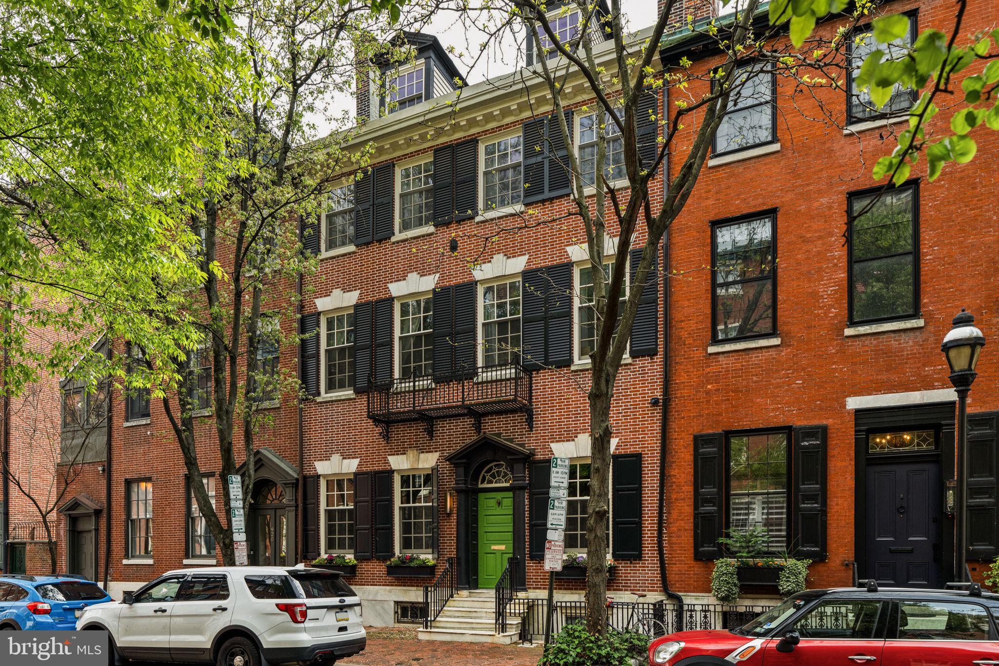 Unique opportunity to purchase a fully renovated, 28-foot wide historic townhouse on storied Clinton Street with a 2-bedroom condominium connected to the main house through a private courtyard. Built in 1848 for a prominent Philadelphia lawyer & politician, Thomas Sergeant, and his wife Sarah (granddaughter of Benjamin Franklin), it was expanded and renovated in 1901 for the Baily Family, and then years later used and operated as "The Columns on Clinton" bed & breakfast before undergoing a complete renovation/restoration in 2016 by the current Seller. The first level is striking, with high ceilings, herringbone floors, three fireplaces (2 wood-burning), and many original details. The living room features modern built-ins and an archway (pocket door) that leads into the dining room and adjacent kitchen. The kitchen was thoughtfully designed with custom cabinetry and Amuneal brass and walnut shelving, quartz counters, and high-end appliances, including a La Cornue range and hood. French doors off the dining room lead to the landscaped courtyard shared with the included condo. At the center of the house is the grand staircase, which is illuminated by natural light from the stained glass skylight at the top. A conveniently tucked away powder room is located at the landing between the 1st and 2nd levels. The 2nd level of this home is the primary suite with a spacious bedroom, an ensuite bathroom with a soaking tub, seamless glass walk-in shower, two custom vanities, and heated floors. Off of the bathroom is a walk-in closet with custom built-ins and a smartly concealed washer and dryer. Also on this level is an additional room with a handsomely built wardrobe, accessed directly from the bedroom and hallway, for use as a dressing room, home office, or nursery. Mural Art by Miriam Singer, installations at PHL and on SEPTA buses. The third level of this home features three bedrooms and a hall bathroom with a bathtub/shower, tile surround, and a vintage-style trough sink with triple faucets. The top level is multi-purposed and lends itself as a guest suite, playroom, and rec room. The main room has vaulted ceilings, a kitchenette, an adjacent bathroom, and a separate bedroom. An Ipe roof deck with city views, outdoor speakers, a gas line, and a water bib can be accessed through the top level. A fully finished basement completes this home, with access from Clinton Street and the rear courtyard. Other features include multi-system/zones HVAC, radiant flooring, In-ceiling speakers throughout, Crestron smart home system and lighting, and a state-of-the-art Security system with installed cameras. An EV parking space & charging station is located directly outside this property. The Seller leases a parking space on the block and will pay for 1 year of parking there. The condo is deeded separately as 925 Pine Street, Unit 2. It is over 1100 SF on three levels and features two bedrooms, two bathrooms, plus a loft. The condo fee is $350/month. This is an excellent opportunity for multi-generational living, an au-pair/guest suite, or use as an income-producing unit. This prime Washington Square West location is within a few blocks of Segar Park and Whole Foods & Acme and is surrounded by some of the best neighborhood restaurants and local shops. Also convenient to Pennsylvania Hospital & Jefferson Medical. Located in the McCall Elementary School catchment.