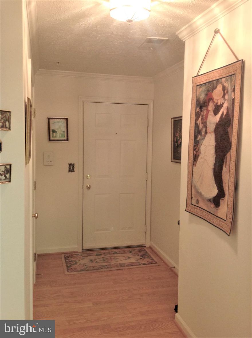 Well cared for and gently lived in second floor unit has 2 bedrooms and 2 full baths.  Good size storage closet in the unit. Full size washer and dryer in the unit.  Partial laminate wood-grain flooring and partial carpeting. Owner had crown molding installed, also had storm/screen door installed to private balcony, new disposal, dishwasher never used. Elevator building, and assigned parking space. One full bath has a tub/shower and the other is a walk-in shower stall.