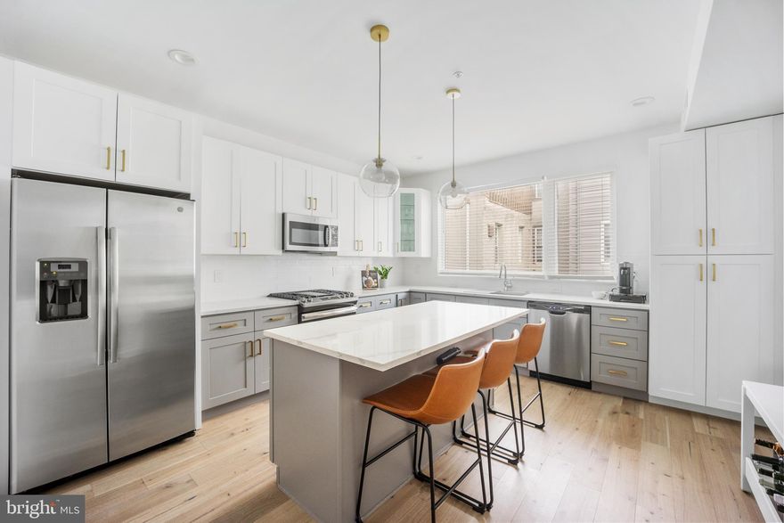 Now priced to reflect today’s market—this modern townhome pairs space, parking, and tax savings in one smart move. 1925 N Palethorp Street offers 3 bedrooms, 4 baths, over 2,300 square feet, a 1-car garage, multiple outdoor spaces, and approximately 4 years remaining on Philadelphia’s tax abatement.
Built in 2020, the home features a bright, open second-floor living level with floor-to-ceiling windows, hardwood floors, and an open living and dining area ideal for entertaining. The kitchen includes quartz countertops, stainless steel appliances, a large center island, and modern cabinetry.
Outdoor living includes a ground-level patio plus a rooftop deck with wet bar and beverage fridge—perfect for entertaining and skyline views.
The flexible layout offers a ground-floor bedroom or office with a full bath, a finished basement with full bath, flex space and laundry, and a third-floor primary suite with two closets and an en-suite bath. A second third-floor bedroom also features its own full bath.
Set on a newly regraded street with updated utilities and surrounded by new construction, the home is two blocks from a brand-new full grocery store, near SEPTA bus routes, and within walking distance to Berks Station on the Market–Frankford Line. Minutes to Fishtown and Northern Liberties. Walk Score: 84.
Garage parking, security cameras, high-speed optical internet, and modern cabling complete the offering—paired with the long-term benefit of remaining tax abatement.