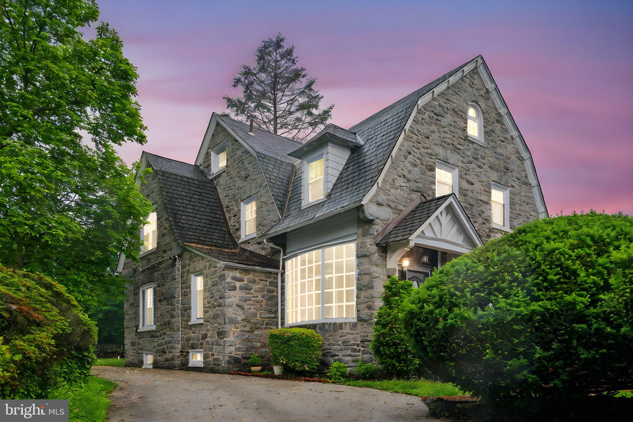 Magnificent fully detached Wynnefield mansion elegantly updated and perched atop a .25-acre homesite steps from City Avenue. Arresting curb appeal with solid fieldstone exterior, dramatic rooflines, stately mature foliage, English-style gardens, gated entry. Leaded-glass vestibule opens to majestic foyer with soaring beamed ceilings, gleaming oak floors, sparking chandelier, arched entryways, extensive millwork, stunning turned staircase, masonry fireplace with wooden mantle and benches. Formal dining room with sophisticated crown molding, oversized window casings, towering windows for superb natural light. Sprawling living room with crown molding and striking picture window with leaded-glass sidelights. Beautifully updated kitchen with solid granite surfaces, handsome cherry cabinetry, stainless appliances including floating vent hood and in-counter gas range, undermount sink, gooseneck faucet, sprawling breakfast area. Updated half bath with floor-to-ceiling ceramic. Upper two floors feature 6 expansive bedrooms offering endless combinations of flexible living space including guest quarters, in-home office space, conversion to one or more walk-in closets, in-home gym, and 3 luxuriously renovated full bathrooms, including one private en-suite bath. Second-floor deck overlooks private, wooded homesite. Cavernous unfinished basement for endless storage. Off-street parking comfortably accommodates 3 cars, deep 175’ lot offers abundant yard space. The grandeur and opulence of a Main Line estate without the Montgomery County taxes! Shows beautifully!