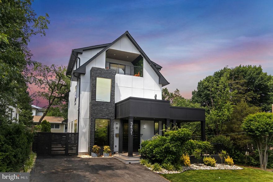 More Photos Coming 2/15 - Home is Only 5 years old, but the owner is doing a COMPLETE refresh to make it feel brand-new! Incredible opportunity to own a like-new, fully custom home built in 2021, offering unmatched luxury, design, and location—all at a price far below comparable new construction. Situated on a premium corner lot with a rare wraparound porch and not one but two private driveways, this property showcases stunning panoramic views of the Arlington skyline. The exterior has been recently refreshed and features Marvin Integrity wood casement windows with UV tint, brand-new hardwood flooring, and fresh paint and caulking throughout. A fully fenced backyard, in-ground irrigation system, soffit and uplighting, and wiring for exterior security cameras add to the home's thoughtful design and comfort. Inside, the open-concept layout is filled with natural light thanks to 10-foot ceilings and 8-foot custom windows on the main level. The show-stopping gourmet kitchen is unlike anything in this price range, featuring top-of-the-line Meile paneled appliances, custom cabinetry, instant hot and filtered water, book-matched backsplash, a striking gold powder-coated range hood, LED motion-sensor under-cabinet lighting, and dual built-in pantries. The main level also includes a formal dining room, a front living room with a bay window, and a family room with a fireplace, surround sound, custom lighting, and an LED-lit bar with shelving. A custom-built open staircase leads to two upper levels with four bedrooms and three full bathrooms, including two primary suites. The primary suite includes a custom closet system and a luxury spa-inspired bathroom with a 9-foot dual vanity, oversized walk-in shower for two with body jets, skylights, ceiling speakers, and ambient LED lighting. The upper-level loft offers a second primary suite with a wet bar, beverage fridge, ceiling speakers, and a private balcony with sweeping views of Arlington—an ideal retreat or guest suite. The finished lower level is perfect for entertaining or multigenerational living, offering a large recreation room with a built-in closet, a full bath, and a second kitchen area complete with fridge, sink, dishwasher, and under-cabinet LED lighting. From here, walk out to the covered lower-level patio for seamless indoor-outdoor living. The oversized one-car garage includes custom cabinetry and built-in storage solutions. Additional features include whole-home built-in ceiling speakers with a centralized control system in the basement, three-zone HVAC for efficient climate control, and modern systems throughout. The location is just as impressive—only a 7-minute walk to two Metro stations, with easy access to restaurants, gyms, coffee shops, grocery stores, and more. Families will appreciate the ability to walk children to school and enjoy two expansive parks just blocks away. Quincy Park and Hayes Park offer tennis courts, basketball, volleyball, ballfields, playgrounds, water features, running tracks, and access to the Custis Trail. This truly unique property offers custom design, high-end finishes, modern systems, and unbeatable walkability in the heart of Arlington. The original home was taken down to the foundation and rebuilt in 2021. All photos are an accurate depiction of the home.