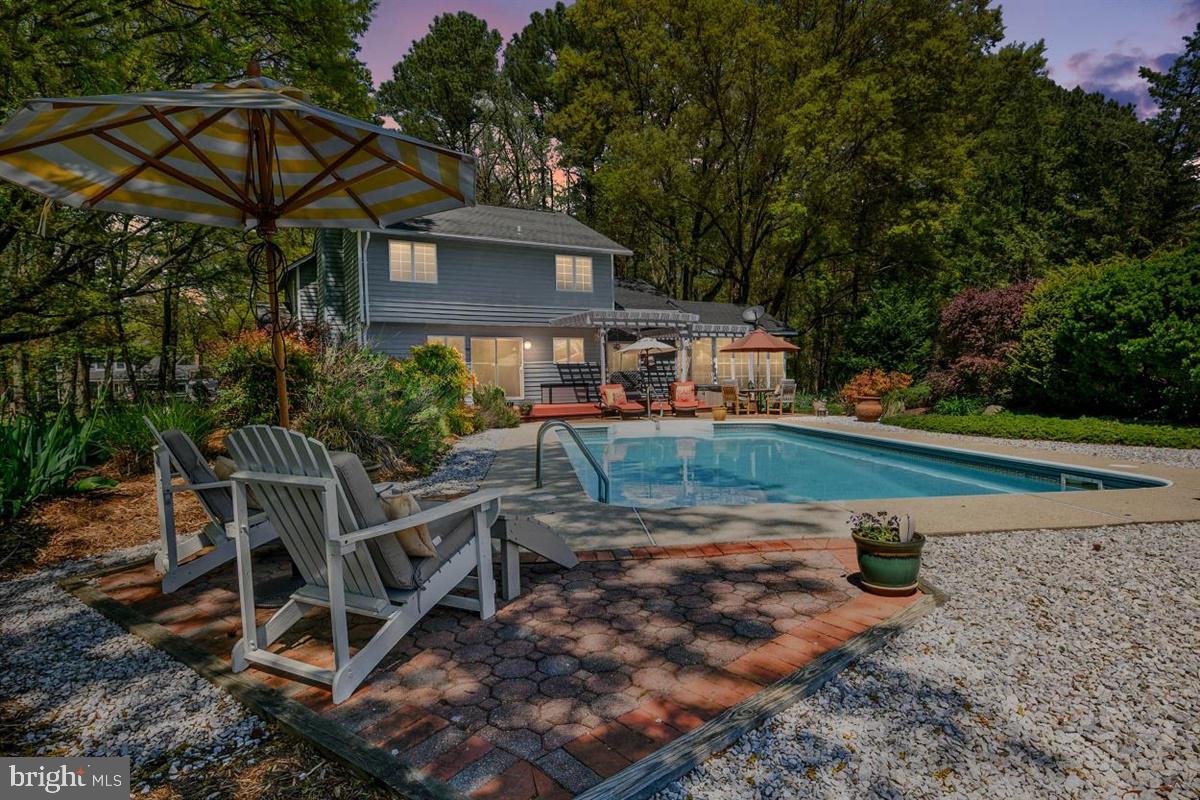 3D Tour: https://unbranded.youriguide.com/113_queens_colony_high_rd_stevensville_md Welcome to 113 Queens Colony High Road in coveted Queen Anne Colony. Come enjoy ALL that this home has to offer. With no neighbors on the left side, backing to the golf course, and a gorgeous backyard oasis, you won't find this amount of privacy or location anywhere else in the neighborhood. This is truly one of a kind!!! This home is boasting OVER 2300 square feet of FINISHED living space!!! Walking up to the home you are greeted by mature, crisp and vibrant landscaping and a relaxing front porch. When you enter the home you have a 2 story foyer that is has fresh paint, tile flooring and is open to the living room and dining room. Take a step down and you enter into the warm and inviting living room with the energy efficient pellet stove. This is all open to the dining room area with gorgeous views of the backyard oasis. Off of the dining room is the sun room that is FINISHED living space. This BONUS finished living space has floor to ceiling windows, allowing you to make this the perfect spot in the house to sit, relax and soak in all the nature this home has to offer. This peaceful room offers views of the golf course, pool, and gorgeous landscaping all around. Moving back to the dining room area and down the hall you will enter into the UPGRADED kitchen!! This kitchen is breathtaking. Gorgeous, sleek counter tops, stylish back splash, stainless steel appliances, breakfast bar, custom cabinets and an abundance of counter space and cabinet space. The kitchen is all open to the family room with fireplace. This is the perfect space for entertaining family and guests. The best part of this space is the amount of sunlight beaming through the kitchen windows and family room sliding glass doors all overlooking the golf course, pool, and wildlife!!! Finishing off the main level is the laundry room, half bathroom, and entrance to the 2 car garage. Moving upstairs you have gleaming hardwood floors throughout the entire second level. You are greeted with 3 perfectly sized bedrooms with ample closet space. Bedrooms 2 and 3 offer amazing views of the golf course, pool and wildlife. The hallway full bathroom offers tile floor, fresh paint and an updated vanity. The best is saved for last. The master suite. Welcome to your retreat. Entering the master suite you have fresh paint, gorgeous hard wood floors, his and her closets, and vaulted ceilings. The master bathroom is like being at a spa every day. The shower is over sized and is tiled from floor to ceiling, tiled soap dish, and finishing it off are the glass doors. This is everything you have ever wanted in a master bathroom!!! Now, on to the backyard. This is where you will want to spend the majority of your time!!! Deck, hot tub, pool, golf course, privacy, fenced in yard, what more could you ask for? The summer is waiting for you with this gorgeous set up!!! Freshly painted deck with hot tub, paver patio, concrete patio around the in-ground pool, vibrant landscaping, and privacy all around all over looking the fairways and greens of the golf course. There is no where else you will want to be!! Enjoy the ammenities of this water oriented community and the convenient location of this home. Close to all major routes, water front restaurants, trails, beaches, shopping and less than 10 minutes to the Bay Bridge!! This home is ready for you to call it HOME!!