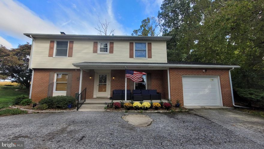 Welcome to 1815 Manchester Rd a quiet place to call home.  This solid 4BR, 3.5 BA colonial with one car garage is situated on a private .55 acre lot offering riding trails and plenty of space for outdoor fun. Inside you'll be greeted by an open foyer which flows to the spacious dining room and kitchen. The kitchen features stainless steel appliances, updated cabinets, quartz countertops and a generous island for family gatherings.  The family room offers a cozy wood burning fireplace to enjoy cooler fall nights and easy access to the full bath with walk-in shower. Get laundry done without all the stairs with the convenient main level laundry room which has a rough-in for a hall bath.  You'll be greeted on the upper level by beautiful hardwood floors and 4 spacious bedrooms with abundant closets and full bath. The owner's suite includes a private full bath with walk-in shower.  Design and create your own space in the unfinished basement which includes a half bath.  The backyard features 2 gazebos, a playset and storage shed.  Improvements include roof approx 2015, water heater 2018, well pressure tank 2019, heat pump 2016, well 2016, kitchen updated 2021. The garage has been recently insulated, drywalled and new insulated garage door with remote. The circular driveway provides additional parking for guests.  This home offers the perfect balance of quiet living just a short distance from all the conveniences you need.