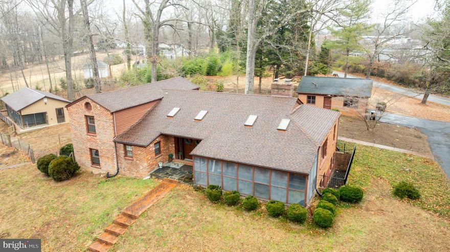 Just a short drive from the Center of the town of Madison.  Come home to this spacious one-of-a-kind brick split level home on 4.5 acres is filled with lots character and charm. Enter through gorgeous Brazilian Mahogany double doors framed with custom stained glass into a beautiful large ceramic tiled foyer. The main level includes spacious rooms with multiple skylights filling them with natural heat and light. Hardwood floors, a separate dining room, and wood burning fireplace in the living room for those cold winter evenings or enjoy the screened porch with a good book, music or just private time. Just a few steps to the upper level which has 2 bedrooms with built in closets with shelves, hardwood floors, and a full bathroom, and you could certainly make this a primary suite with an office and a primary bath.  Directly below are 2 additional bedrooms, a second full bathroom and half bath, and a convenient kitchenette. The basement is finished to include a large recreation/family room with a brick wood burning fireplace, spacious office/hobby room, a 3rd full bathroom, and laundry room. Entertain outside to enjoy the pristine landscaping, a walk around the pond, and even enjoy a bbq on the outdoor brick fireplace. You'll also find the detached 2 car garage as well as an additional 10x40 storage building/shop. Comcast Xfinity high speed internet is here! Call me for a tour.
