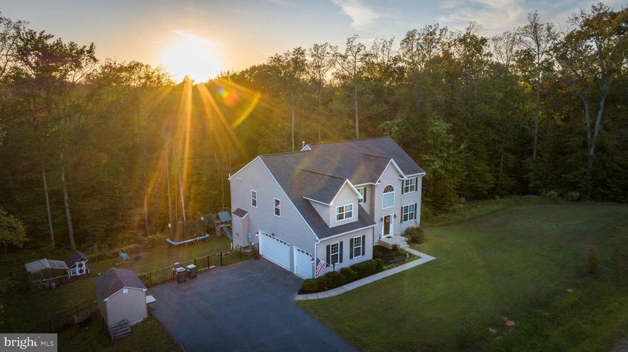 The wait is over! This luxury homestead on 4+ acres is here! Welcome home to 2225 Camp Geary Lane in Stafford County, tucked away near Crows Nest natural preserve, and Aquia Landing. This beautifully built 5-bedroom, 4.5-bathroom home is perfectly situated on 4 private acres with multi-generational appeal and a homestead feel. Built in 2017, this thoughtfully crafted residence offers over 4,700 square feet of finished space, complete with beautiful hardwood floors on the main level, a dedicated home office, and multiple living areas ideal for family life and entertaining. Even better, this home has an assumable 2.5% VA loan. Call for details!

The main level features a formal living and dining room, a spacious family room with a gas fireplace, and a well-appointed kitchen equipped with a gas range and ample cabinetry. Love a pantry? You’ll love this one! The open and light-filled kitchen leads out into the generously sized deck with gazebo cover and a view of the chicken coop, play set, trampoline, tree-jungle gym, and fire pit seating area. Don’t worry, it’s all fenced in with a gorgeous wrought iron secure fence all the way around! 
Upstairs, the luxurious primary suite includes a cozy sitting area, another sitting area nook (or home gym?) an en-suite bath, and a large walk-in closet. Two additional bedrooms are connected by a Jack and Jill bathroom, while a fourth bedroom enjoys its own private en-suite.
 A fully finished walk-out basement offers a complete in-law suite with a NTC bedroom, full bathroom, rec room and game space, perfect for extended family or guests. 

Outside, the property is equally impressive. Enjoy your mornings or evenings on the expansive deck with a covered gazebo, or unwind around a crackling fire. Children and guests will love the on-site playground, trampoline, and jungle gym. A chicken coop adds a charming homestead touch, while a shed and RV parking provide practical storage solutions. The home also includes a side-load, three-car garage with ample driveway space.

This property offers a rare combination of space, functionality, and recreation—all within a peaceful, natural setting. It’s the perfect opportunity for anyone seeking a private retreat with modern amenities and room to grow.